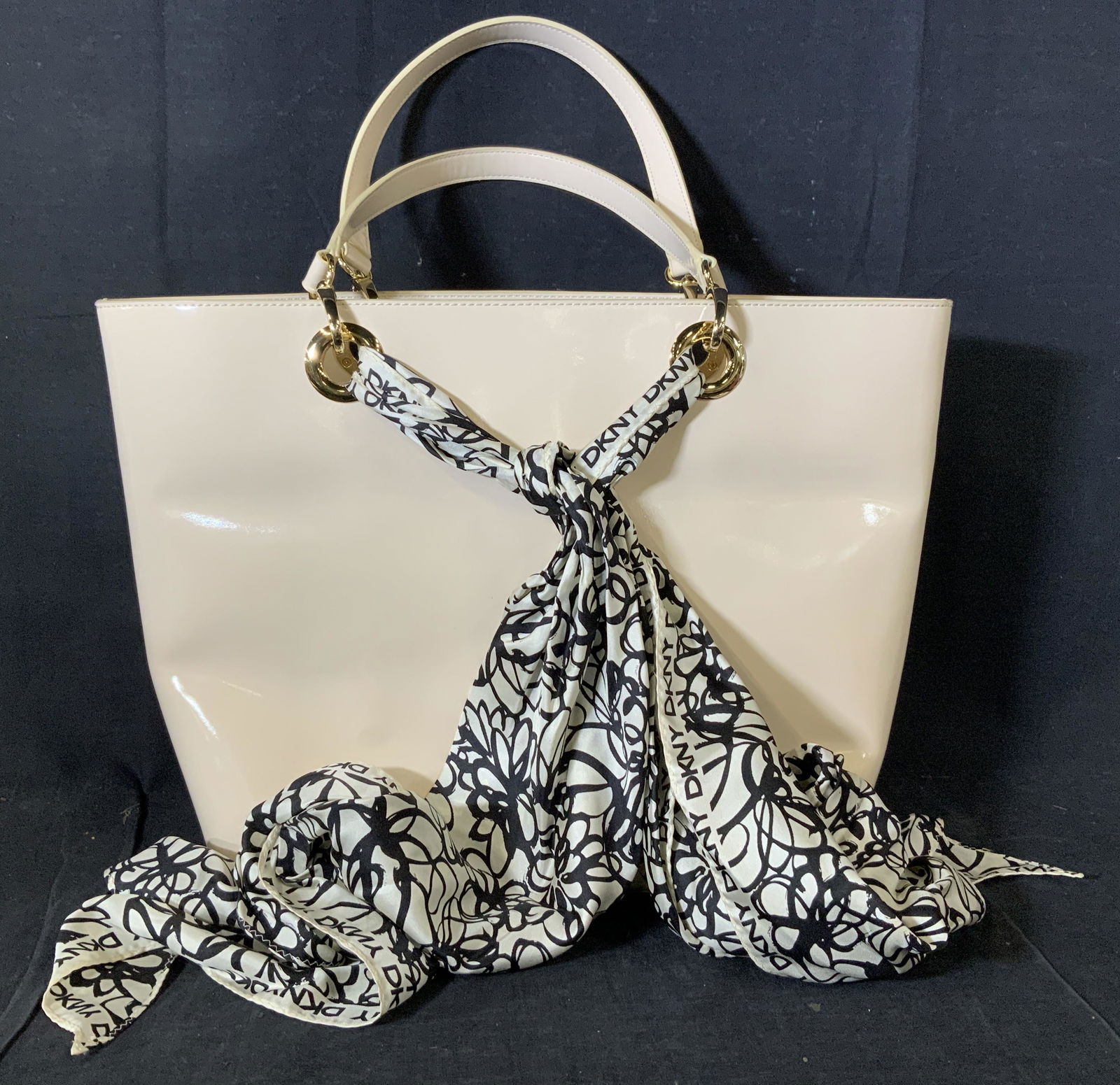 DKNY Patent Scarf Tote Handbag, Org. Tag: Luxury DONNA KAREN NEW YORK Patent Scarf Handbag, buff color, style R1013301, color code 103, RN # 68596. Patent leather tote , buff color, accessory Scarf with DKNY logo tied to bag, gold tone hardwa