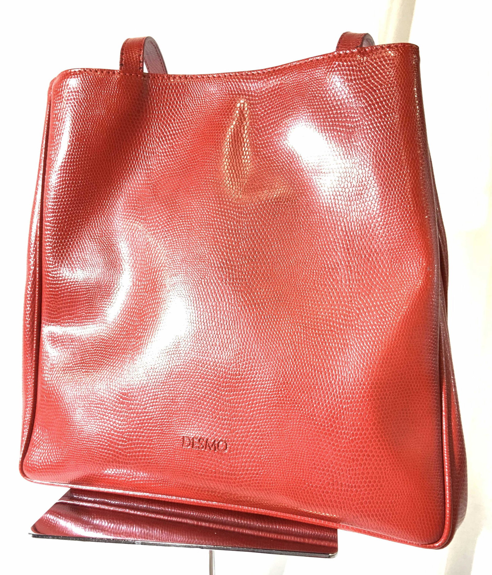 DESMO Red Leather Shoulder Bag, Italy: DESMO handbag, shoulder bag. Bright red. Strap 11 in. L. Taller narrower tote with 2 open interior compartments. 11 in. Ht. Flexible expanding, up to 7 + in. W. Snap closure. Signed label on leather r