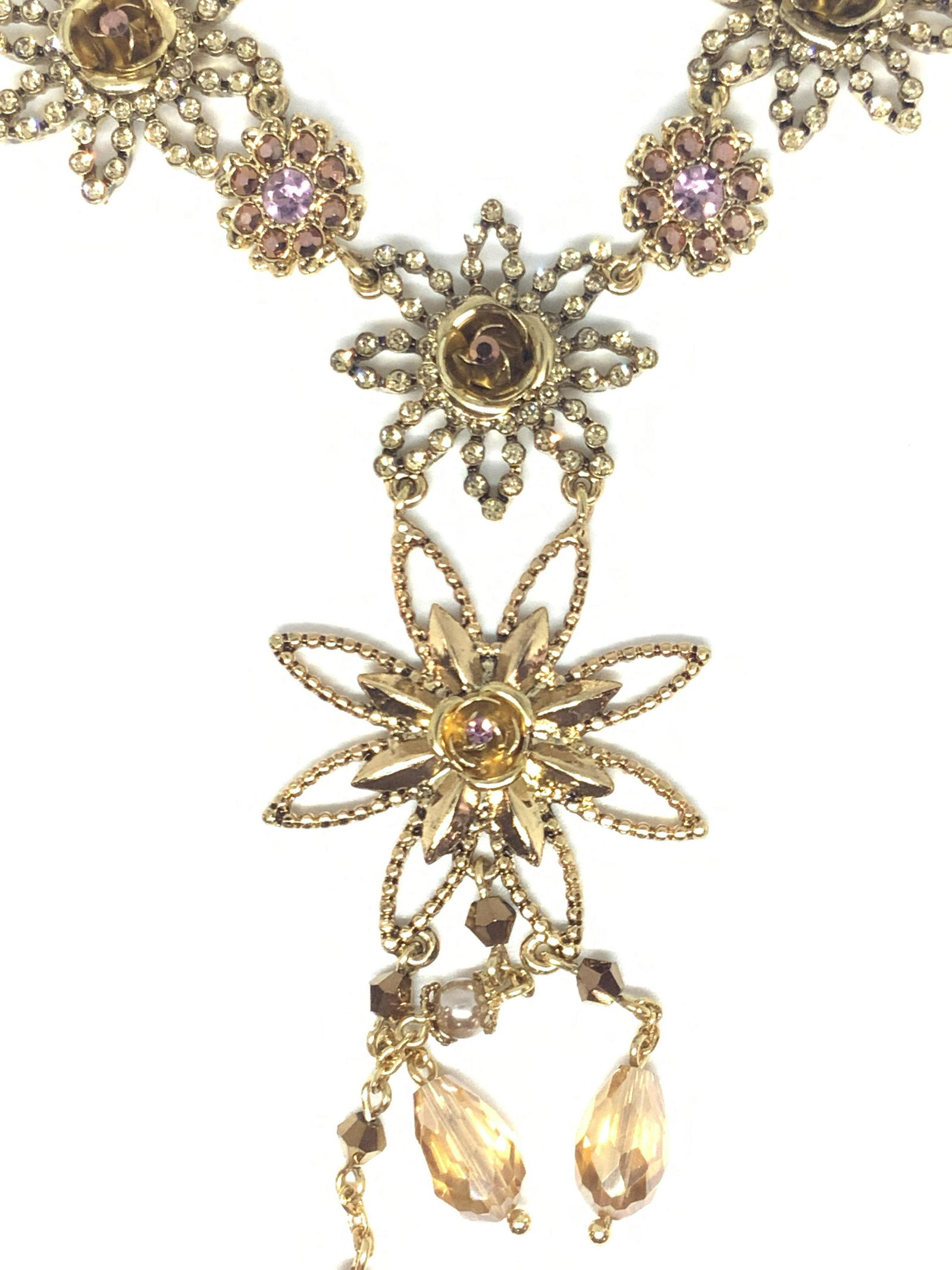 MIRIAM HASKELL Vntg Floral Necklace W/ Org Box: A signed, vintage, Miriam Haskell floral pendant necklace crafted from gold tone metal. The necklace features pink, colorless, and amber toned faceted crystals. The floral pendant at the center has da