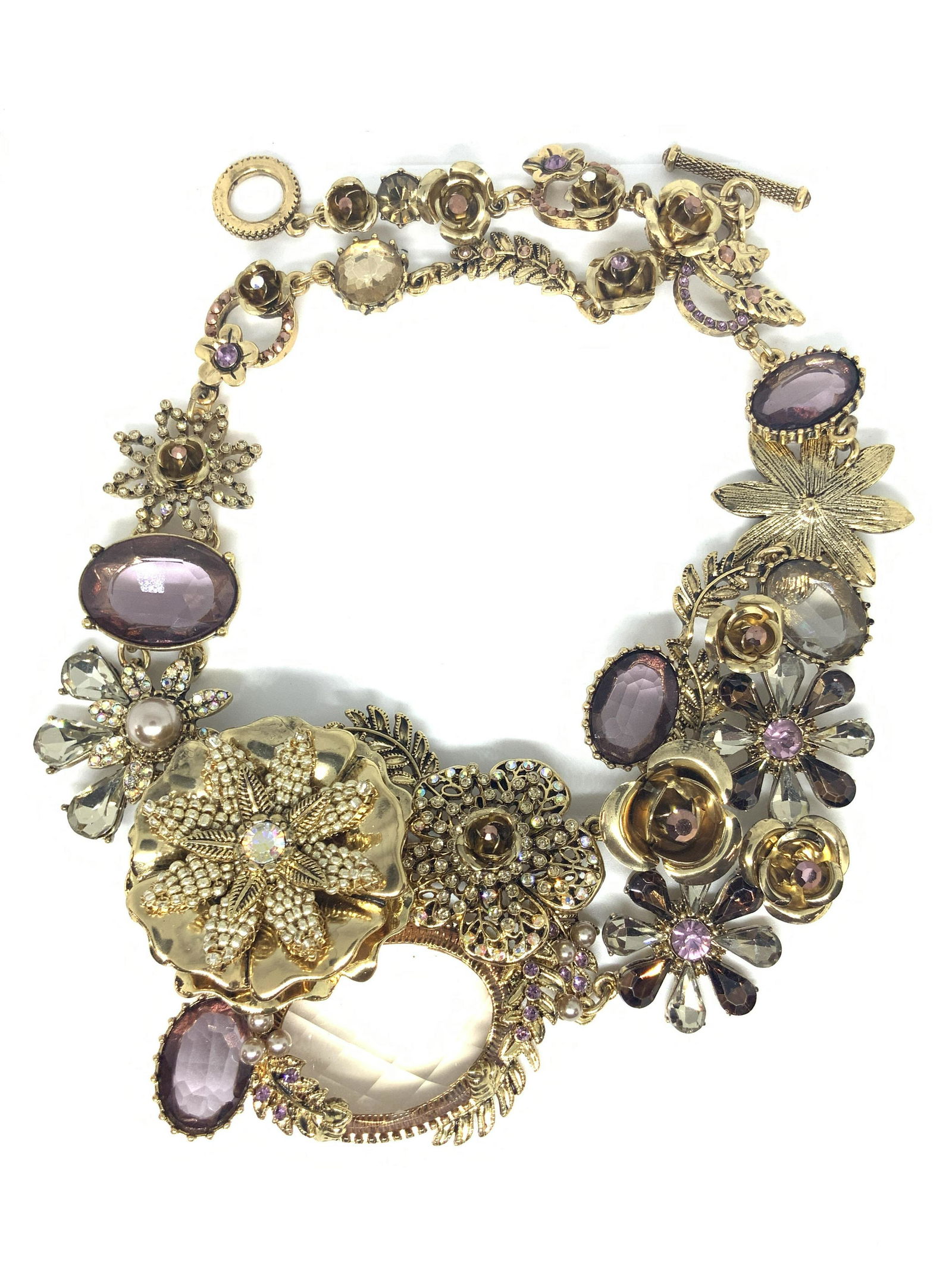 MIRIAM HASKELL Vntg Floral Choker Necklace Org Box: A signed, vintage, Miriam Haskell floral choker style bib necklace crafted from gold tone metal. The necklace features pink, colorless, and amber toned faceted crystals. The floral bib at the is chunk