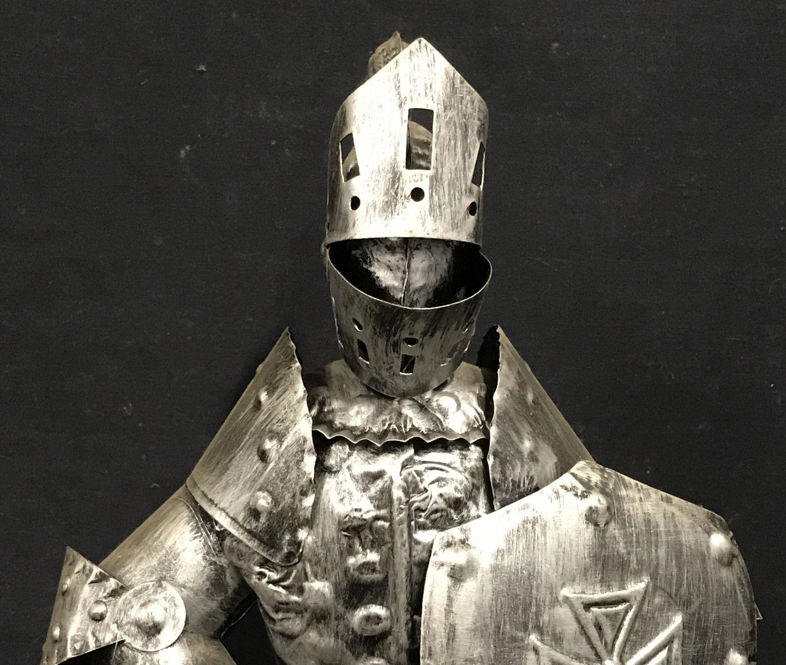 Metal Statue of Knightly Armor with Crossbow: Metal statue of knightly armor with crossbow, no apparent signatures or stamps, subject a set of knightly armor holding a crossbow pointed at the ground, hollow statue, made of a light silver toned me