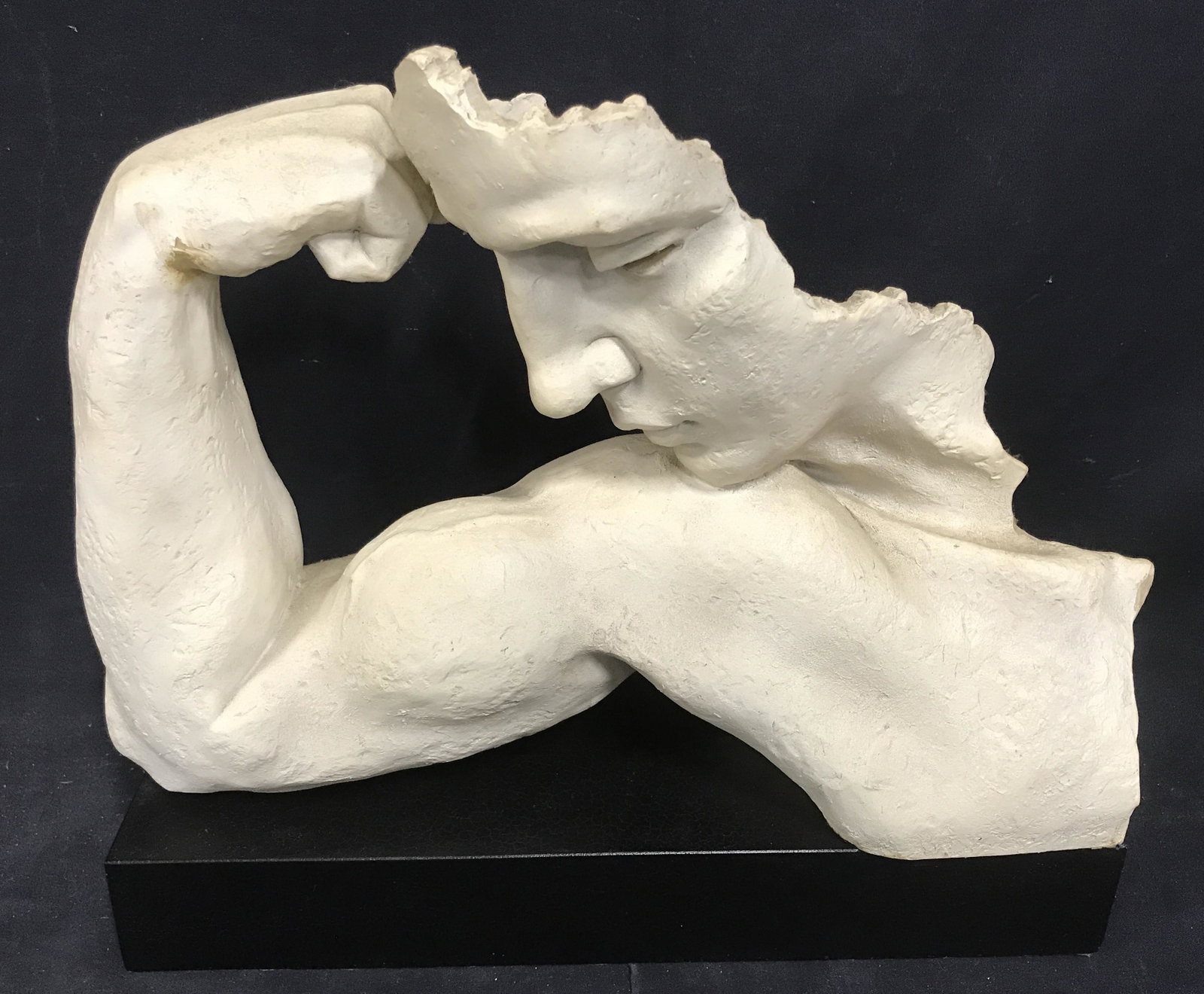 Ceramic Sculpture of Figure, Statue artwork: Ceramic sculpture of figure flexing bicep, no apparent signatures or stamps, subject the hollow face of a man looking to its bicep flexing, ceramic statue atop a black wooden base with felt to its und