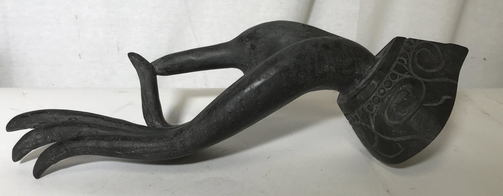Stone Buddhist Hand Mudra Sculpture artwork: Stone Buddhist hand mudra sculpture, no apparent signatures or stamps, subject a hand with thumb and forefinger pressed together hand wears a decorative sleeve, off balanced piece, measures 11.5 inche
