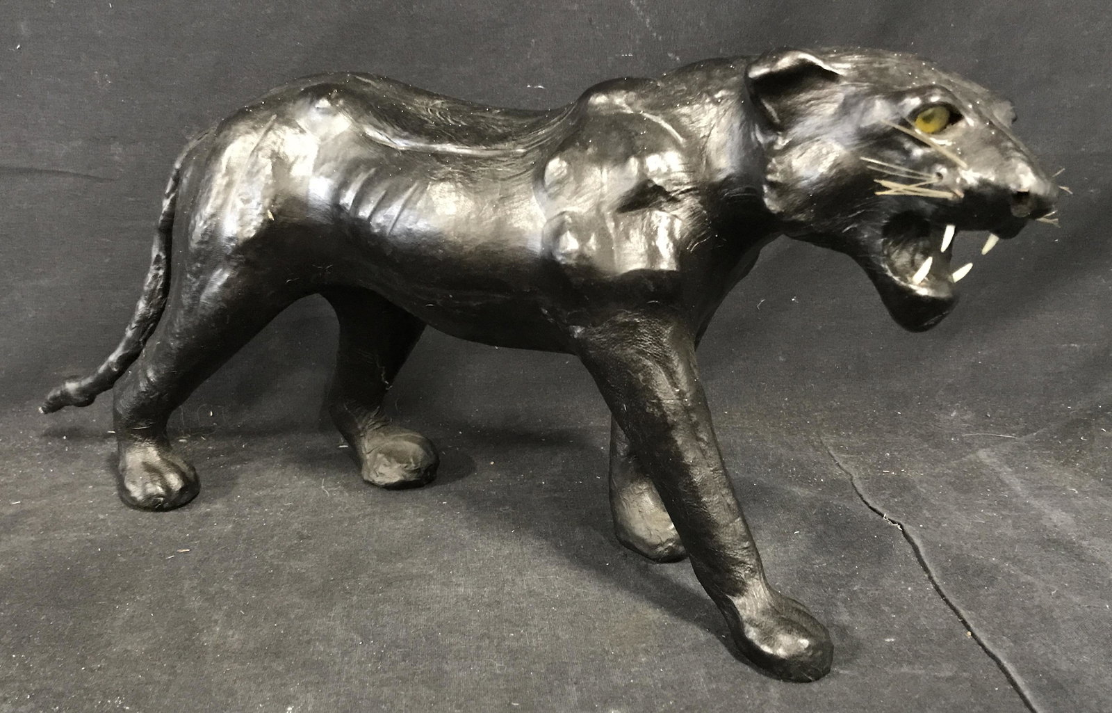 Composite Panther Sculpture, Sculpture: Composite panther sculpture, painted black, eyes teeth and whiskers added, no apparent signatures or stamps some scuffs and wear to surface, overall in good condition, measures 8 inches tall by 17 inc