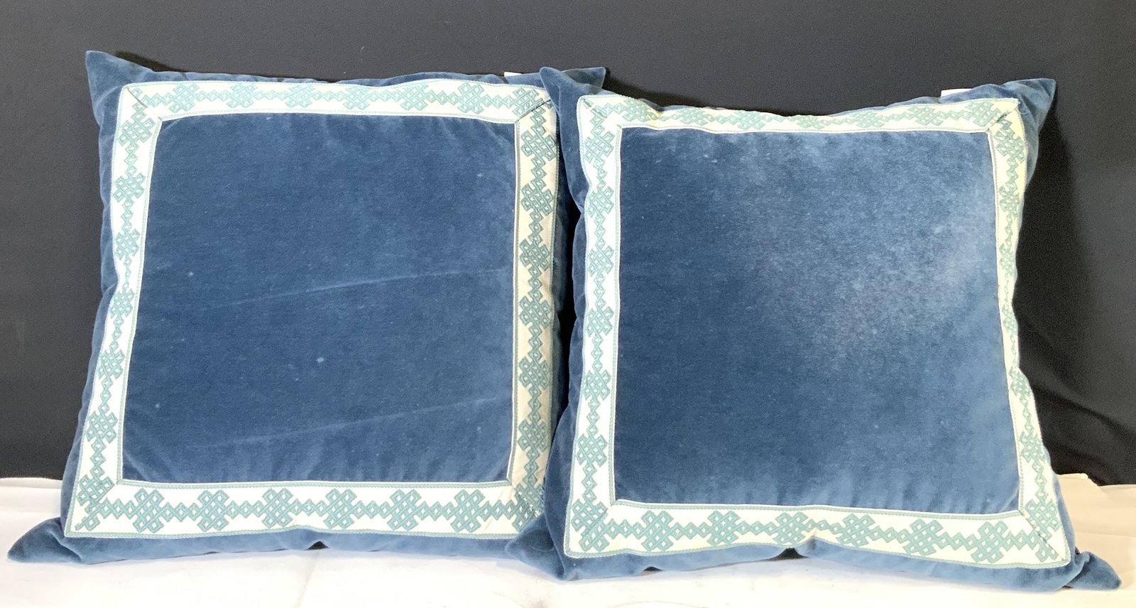 Pair LACEFIELD DESIGNS Denim Velvet Throw Pillows: A pair of feather down blue denim velvet pillows. Stitched blue and white square design along the front. Each pillow has a zipper, can remove the exterior and dry clean. Exterior Tags read: LACEFIELD 