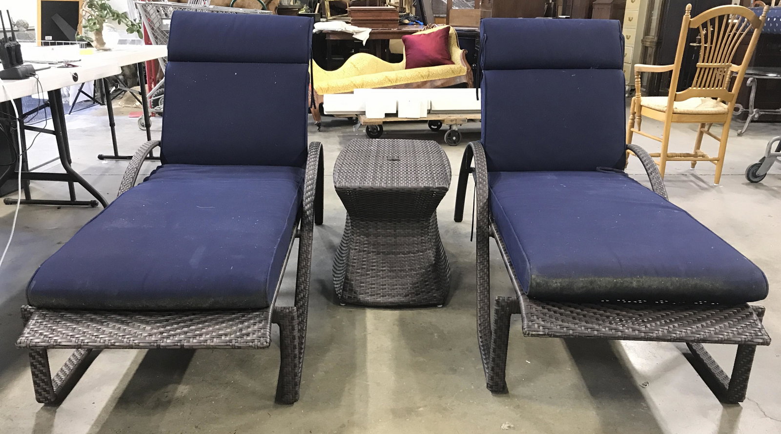 Set 3 Outdoor Woven Wicker Lounge Chairs & Table: Lot includes 2 lounge chairs & matching side table. Each piece is brown toned with woven structures. Lounge chairs have 4 different reclining grooves. Side table has umbrella hole. Lounge chairs inclu