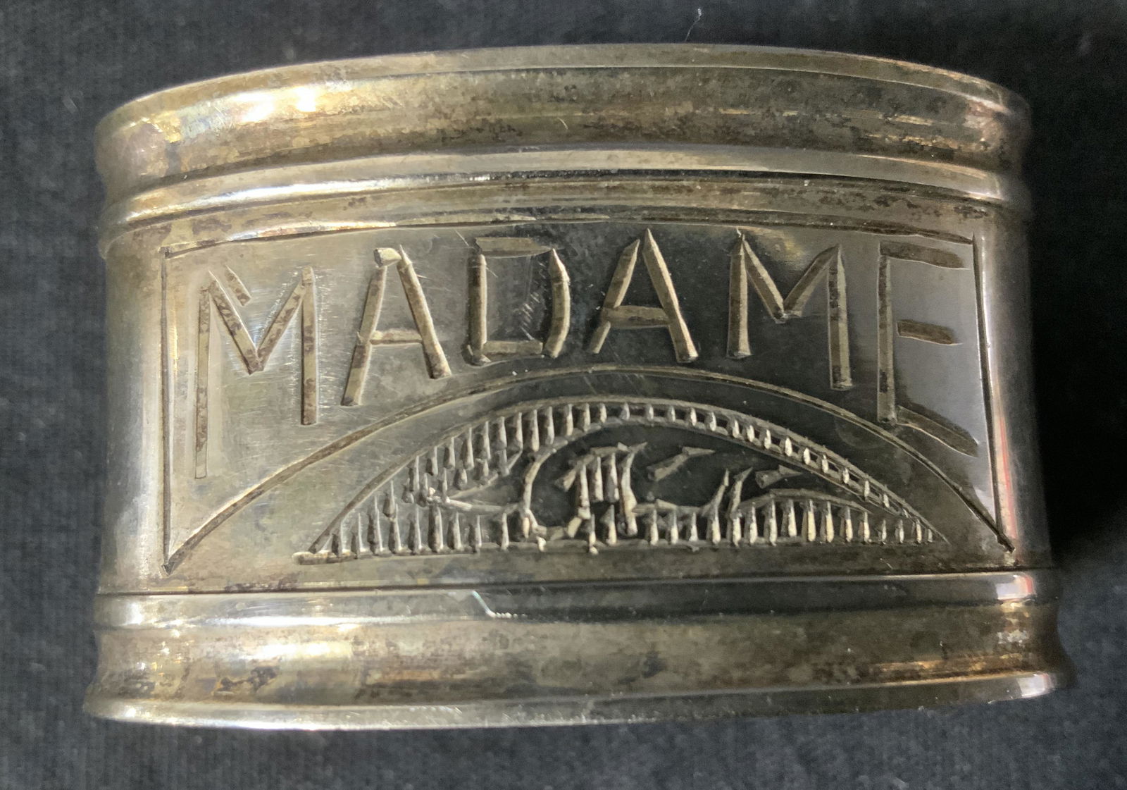 Madame Metal Napkin Ring: Madame Metal Napkin Ring, inscription reads ‘Madame’, measures 1 1/4 x 2 1/8 inches, Madame, metalware, napkin ring, tableware, decorative arts, home decor. 11