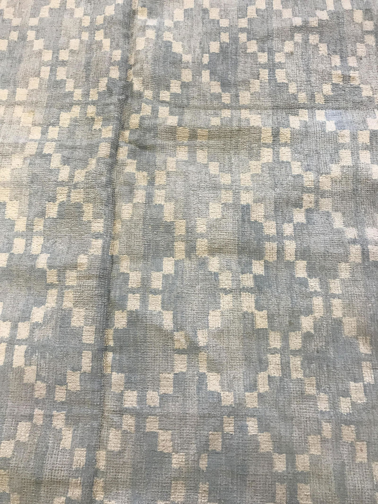 Vintage Dhurri Style Area Rug: Vintage, possibly antique, area rug. Powder blue and white geometric patterns decorate carpet. Measures approx 70 inches long, 70 inches W. Wear is consistent with age and use, lining on underside has