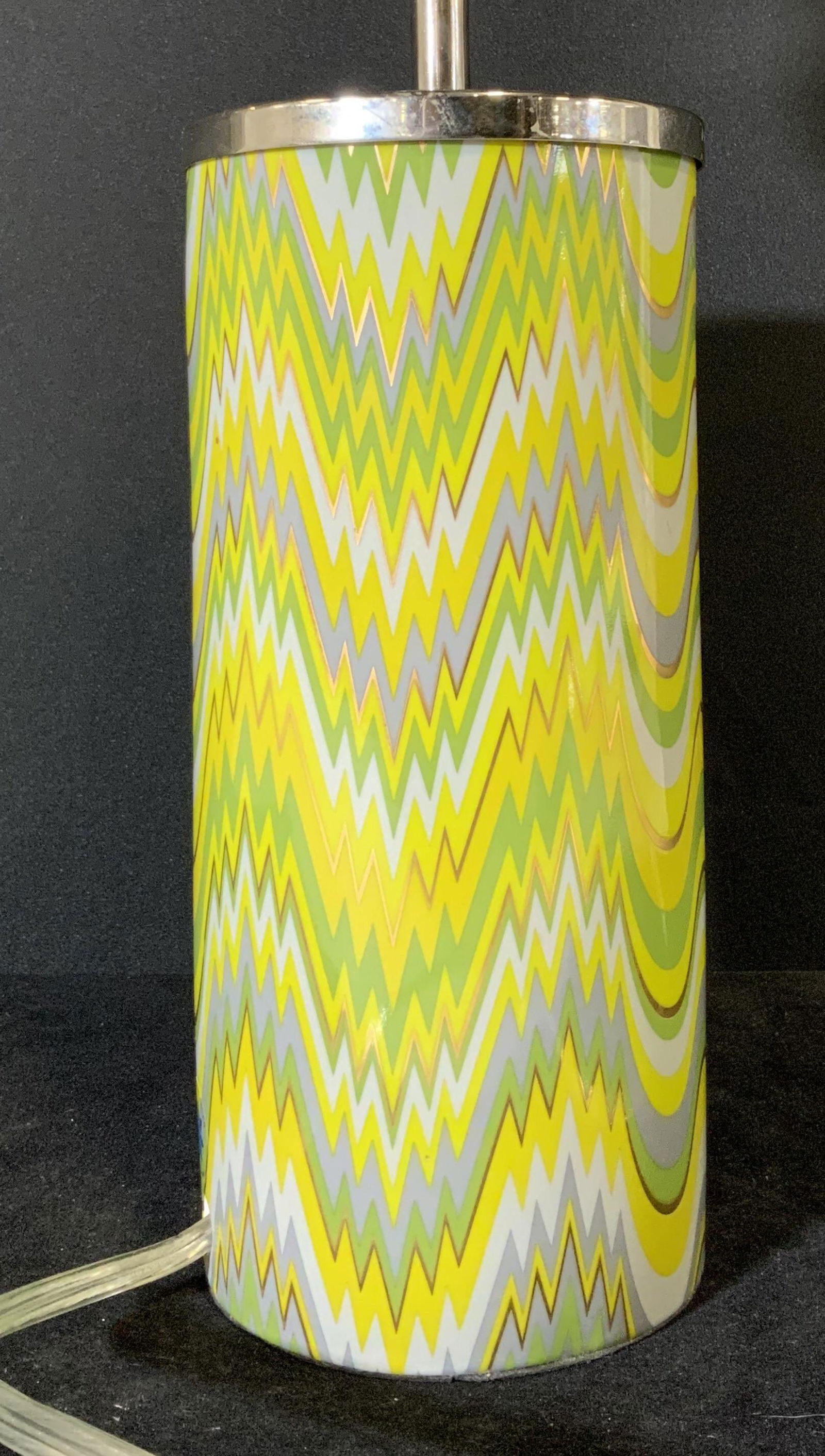 JONATHAN ADLER Carnaby Green Acid Palm Table Lamp: A Jonathan Adler tabletop lamp with erratic zigzag design in shades of green, yellow, and grey. Tone tone accents along the zigzag pattern. Porcelain with metal accents. Sticker near the cord reads: J