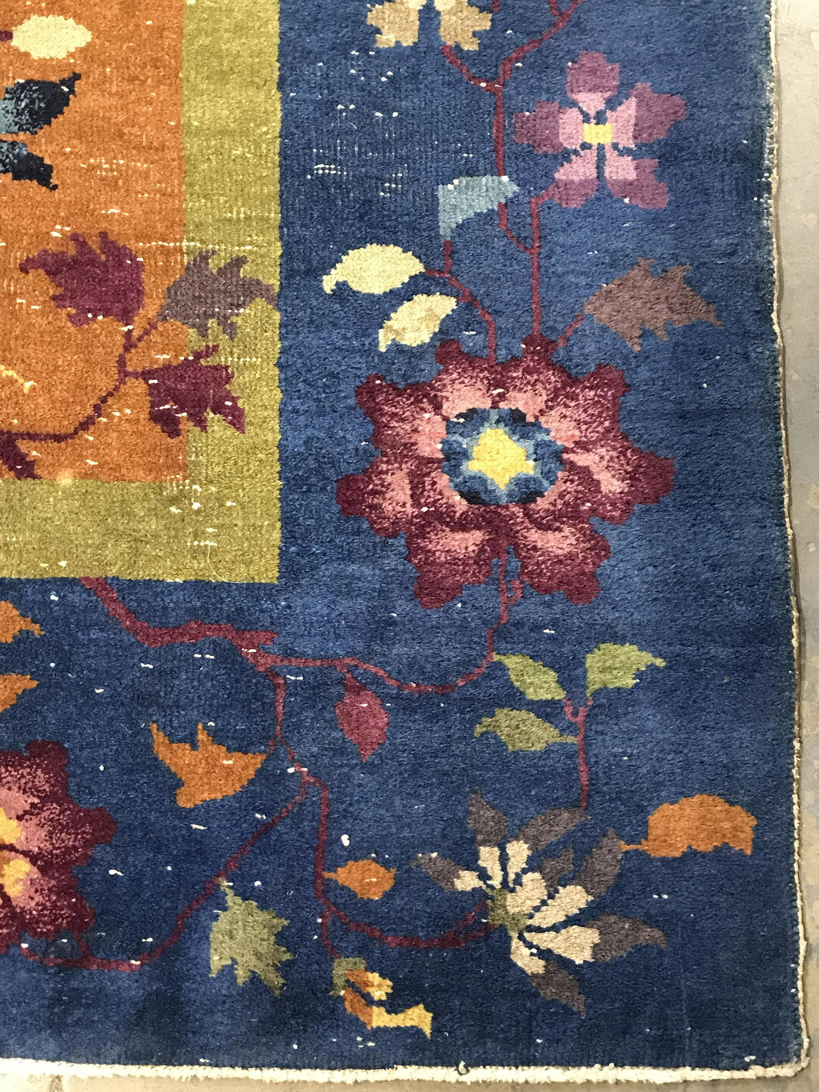Vintage Handmade Chinese Art Deco Wool Rug: Rug is vintage possibly antique. Piece is handmade and wool pile. Rug has multi toned floral, vine and leaf detail. Piece measures approximately 148 inches long 107 inches wide. Rug, carpet, area rug,
