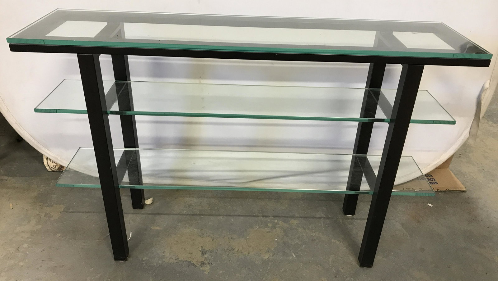 Black Toned Glass Shelved Console Table: Black toned metal console table, possibly vintage. Table top and two shelves are glass, all are removable. Measures approx 28.5 inches H, 45 inches W, and 11.5 inches deep. Wear is consistent with age