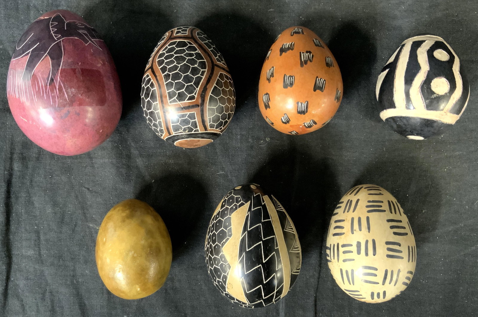 Lot 7 Hand Painted Stone Decorative Eggs: Lot 7 Hand Painted Stone Eggs, no apparent inscriptions or stamps, smallest measures 2 x 1 3/4 inches wide, largest measures 2 7/8 x 2 1/4 inches wide, some surface wear but overall in good condition,
