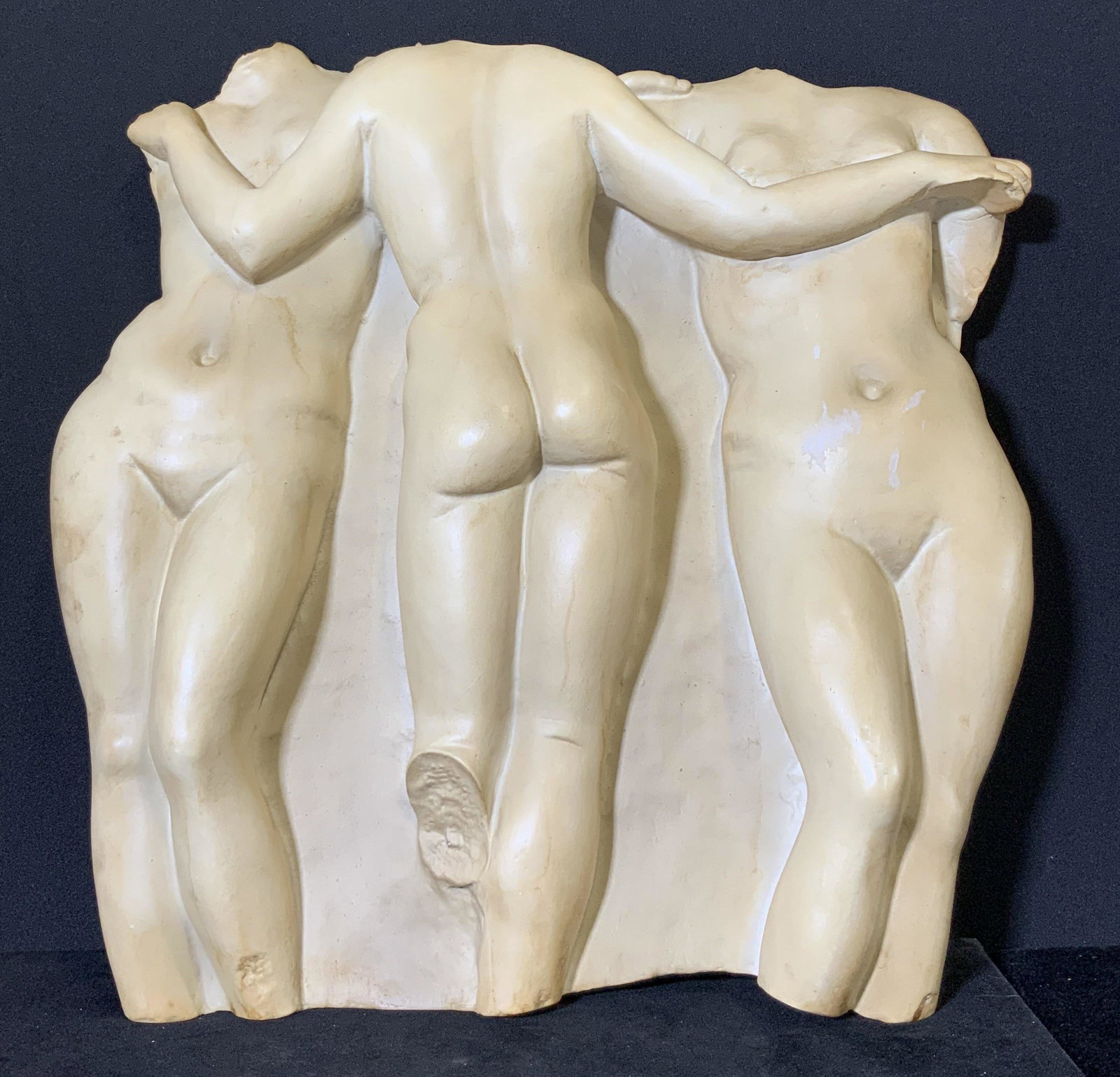 TOSCANO Nude Female Form Artisan Wall Plaque: A composite wall sculpture depicting three nude woman standing alongside one another. Underside sticker reads: European Styled Sculpture Hand Crafted in China for Design Toscano. Underside features tw