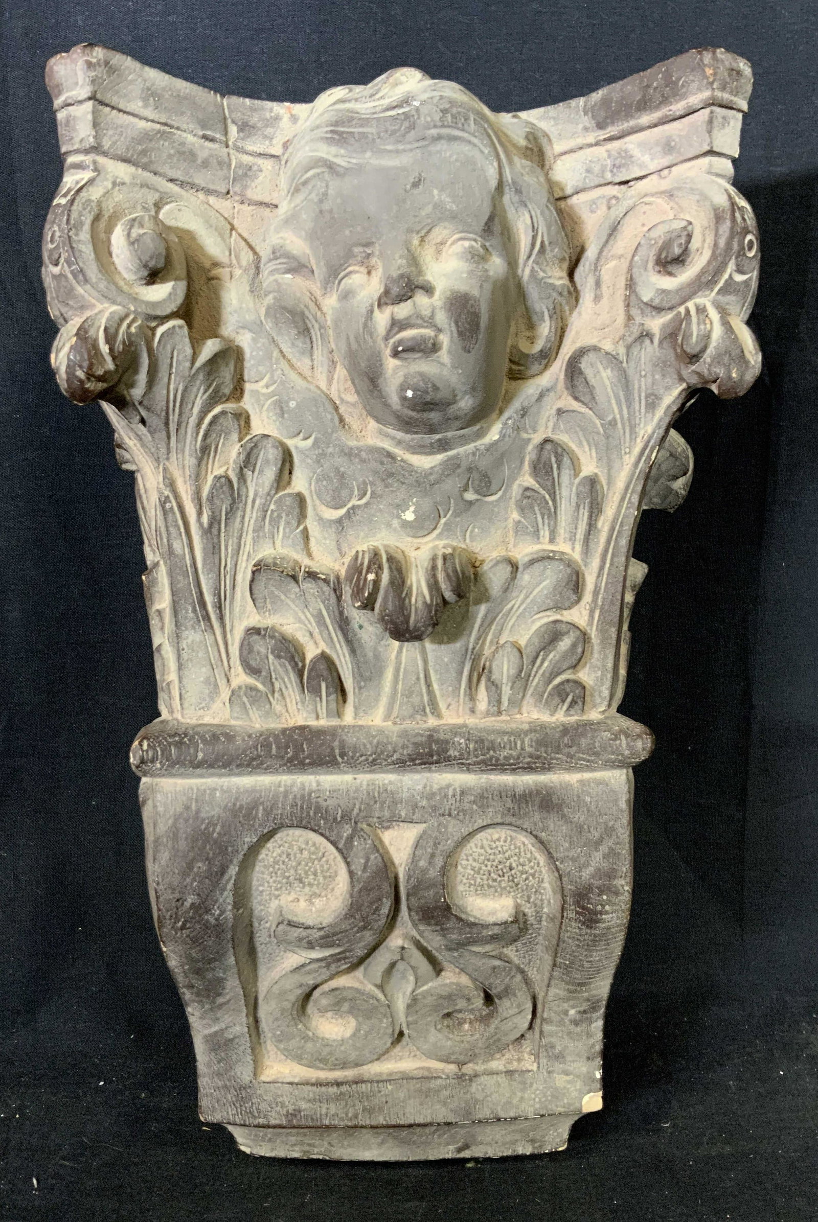 Plaster Putti Wall Sconce: Plaster Putti Wall Sconce, no apparent inscriptions or stamps, a cherub amongst vegetal motifs, measures 15 1/4 x 8 3/4 inches wide, projection measures 6 1/2 inches, some chips and surface wear but o