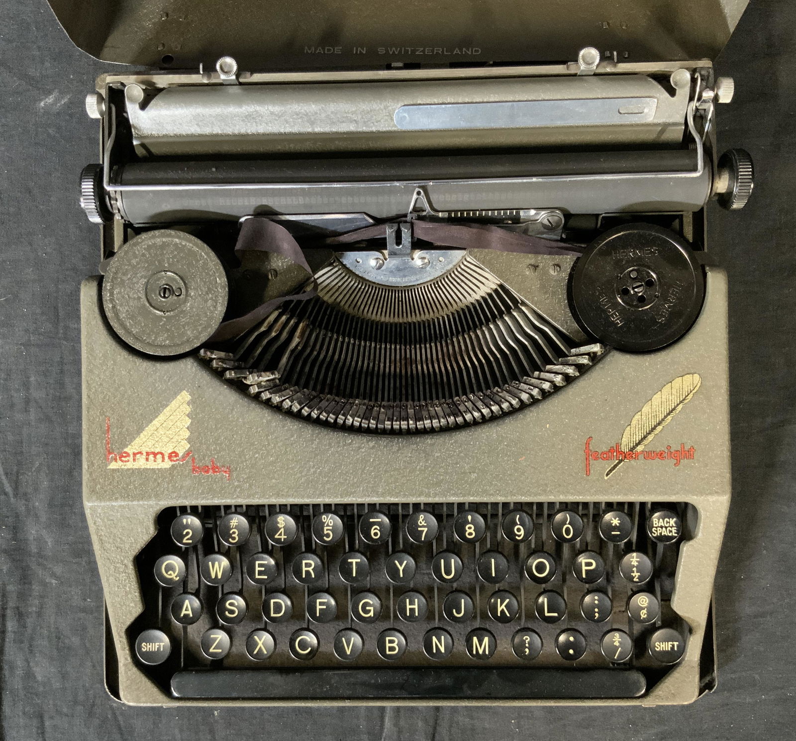 Vintage HERMES BABY Featherweight Typewriter: Vintage HERMES BABY Featherweight Typewriter, inscription reads ‘Hermes Baby Featherweight Made in Switzerland’, measures 2 7/8 x and 11 1/8 inches wide, wear consistent with vintage condition, Vi