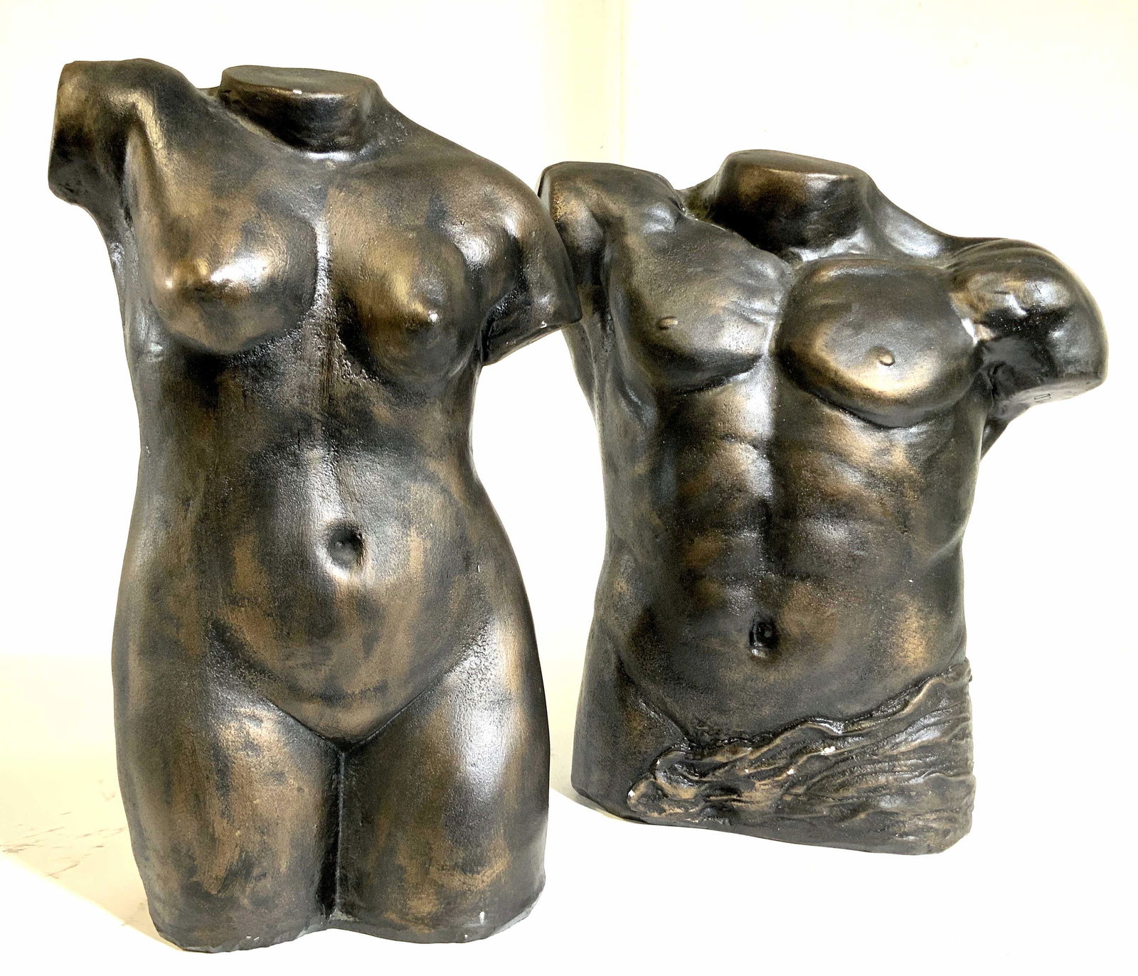 Pr Ceramic Male Female Nude Torsos: Torso sculptures in gun metal gray tones with bronze over wash, nude male and nude female torso sculptures, ceramic, decorative arts decorative objects, each measures app ht 17 inches width 13 inches