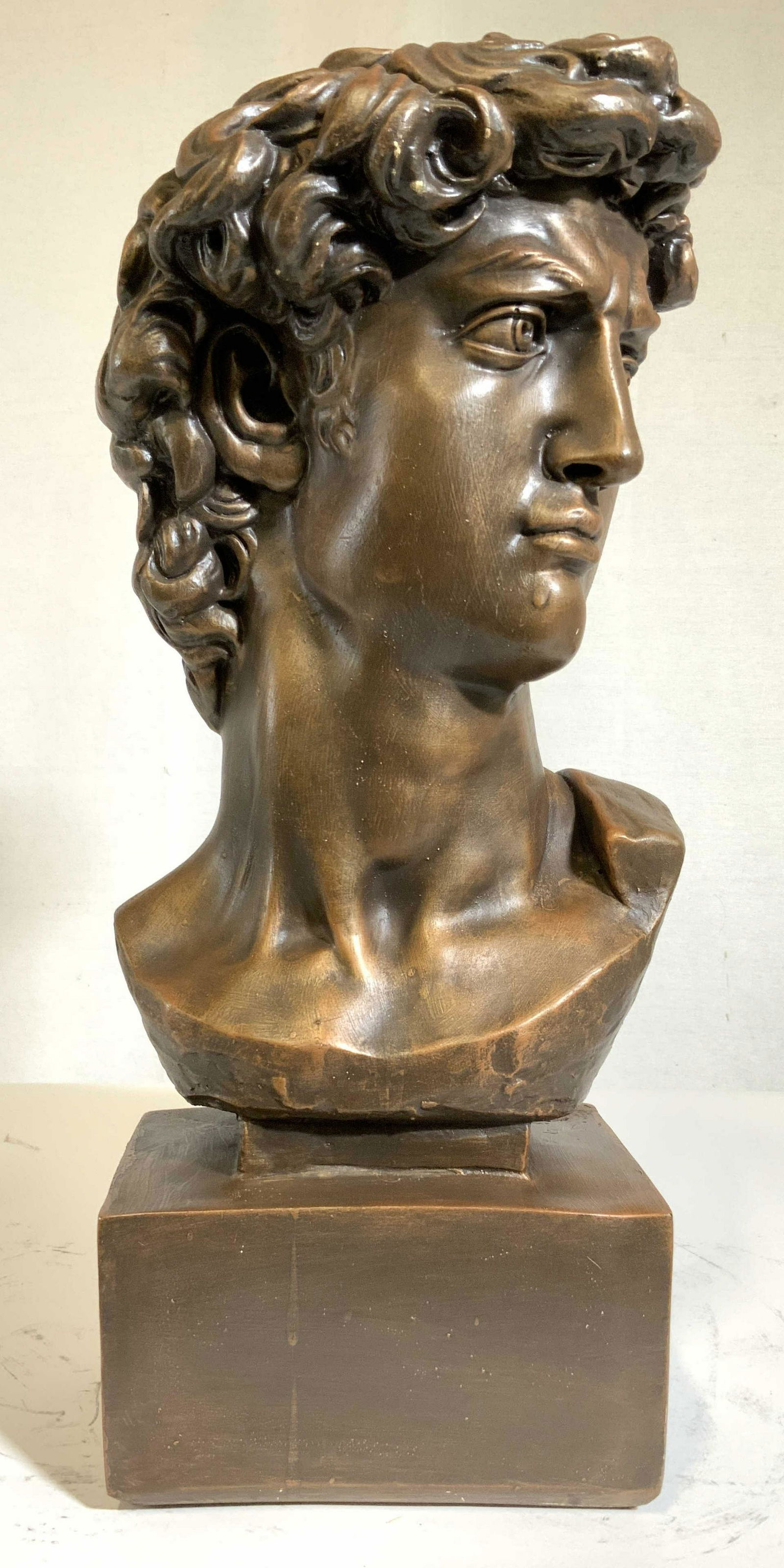 Large Bust Michelangelo's David Sculpture: Composite, head and shoulders in deep copper tones, bust on rectangular base, decorative objects, decorative accessories, measures ht 23 inches width app 13 inches depth app 9 inches Ceramics, ceramic