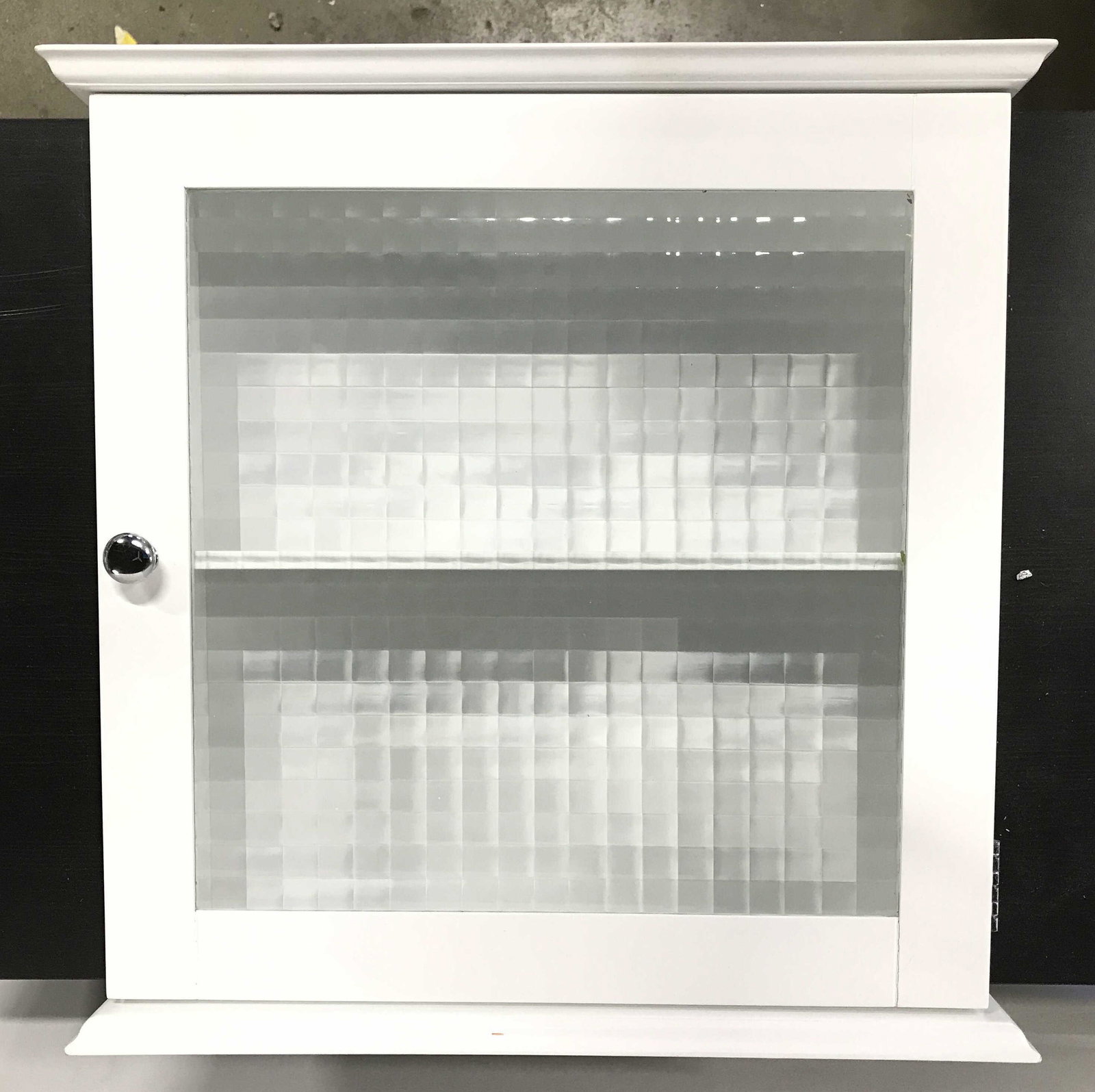 NBC TRADING CO Wall Mount Cabinet W Shelf: Reverse side has tag which reads NBC TRADING CO Wall mount cabinet is white toned and appears to be wooden. Piece has glass door. Interior includes 1 shelf. Piece has silver toned chrome knob style ha