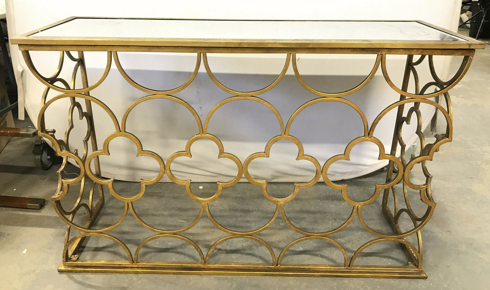 Gold Leafed Metal Mirror Top Console Table: Console table is metal. Piece appear to be gold leafed. Top is rectangular shaped with glass top. Console table, metal console table, bar, mirror top console table, home furnishings. side board, entry