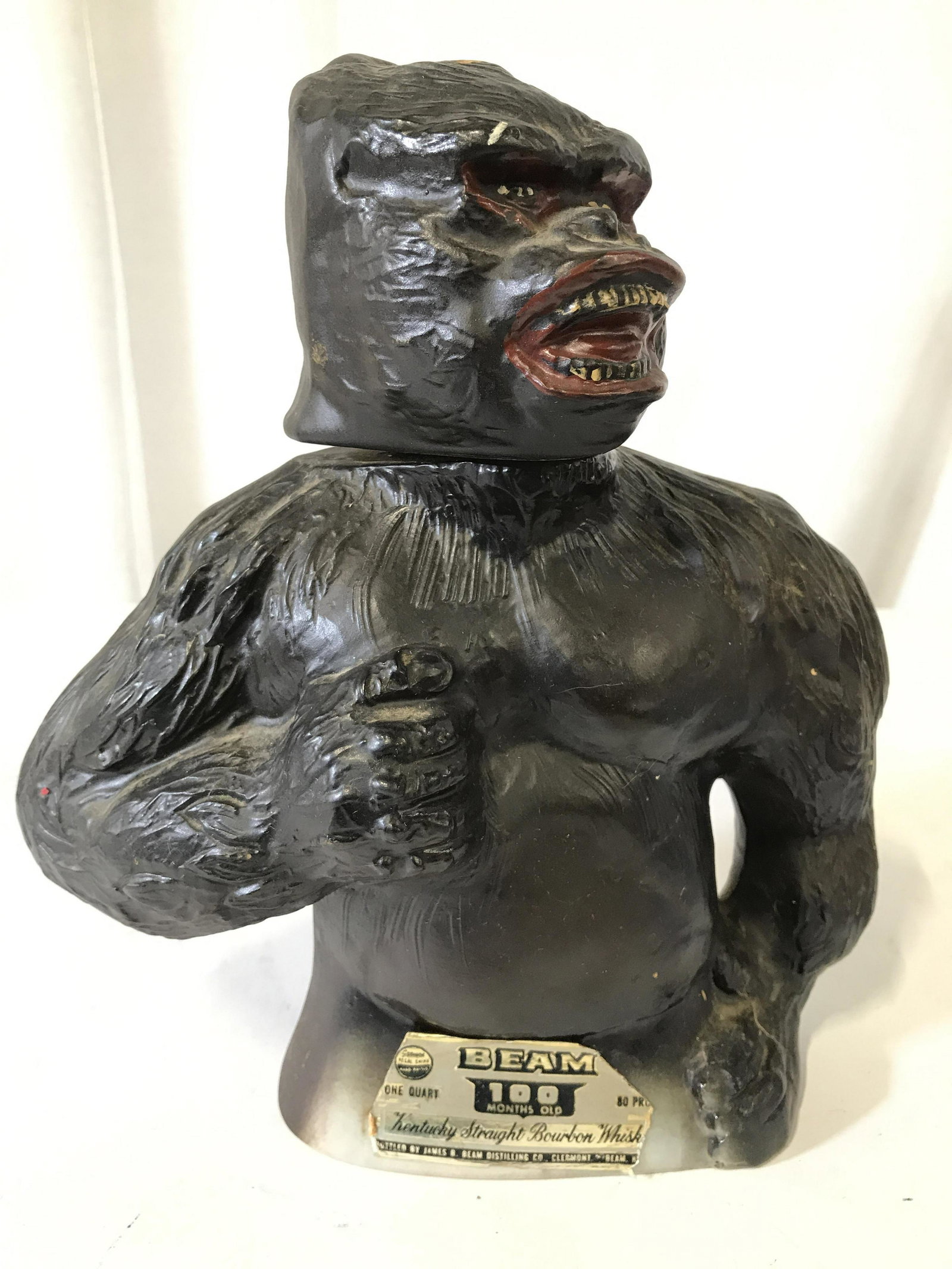 JAMES B BEAM Porcelain KIN KONG Whiskey Decanter: Underside reads creation of JAMES B BEAM. Backside reads KING KONG. Piece appears to be porcelain. Piece is in the shape of a gorilla. Decanter appears to be vintage. Gorilla head acts as stopper. Pie