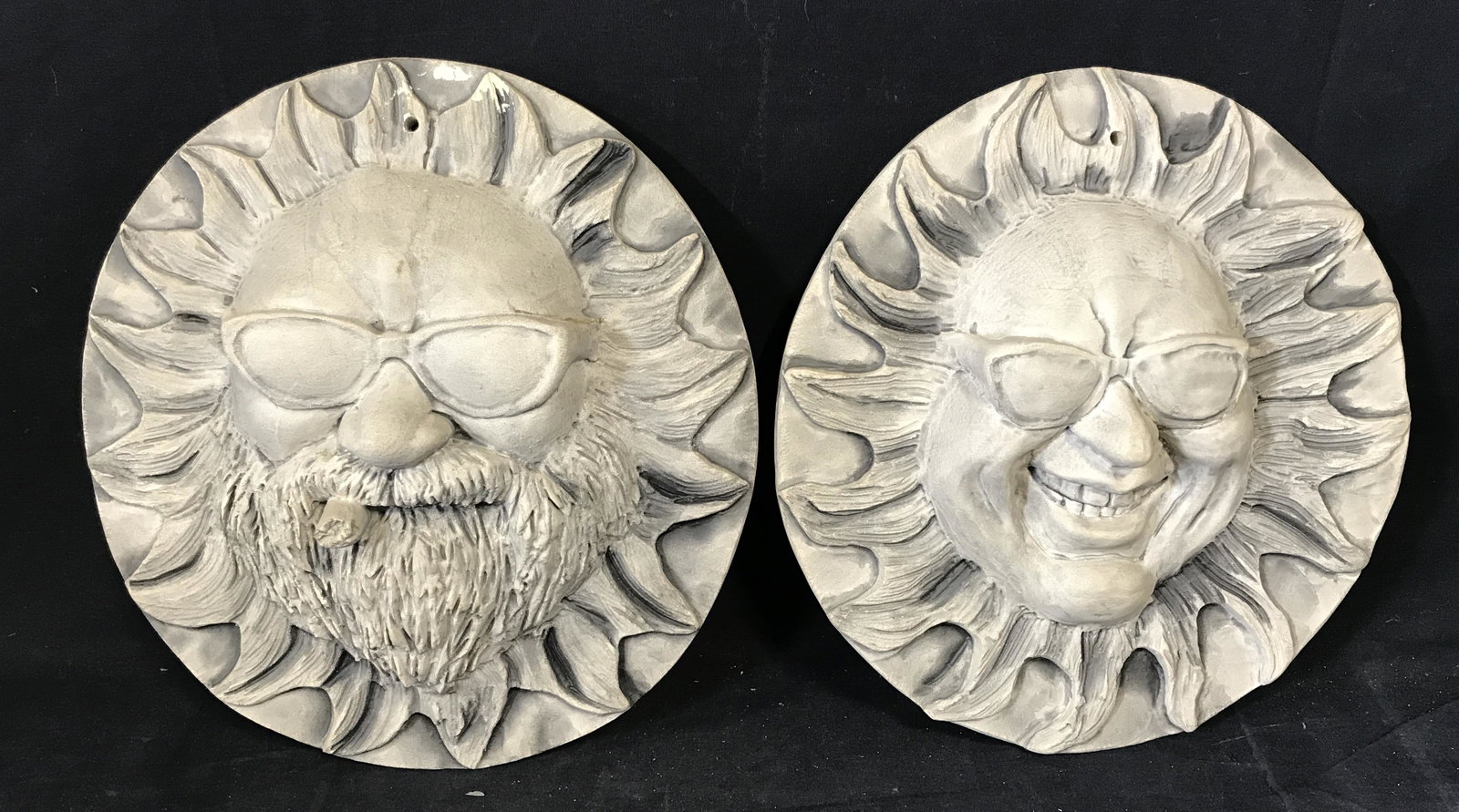 Pair Wall Decor Ceramic Sun Faces: Pair Wall Decor Ceramic Sun faces, label to reverse of both reads ‘JBK Collection’, both display a sun with a face wearing sunglasses except on also has a beard and cigar, both measure approximate