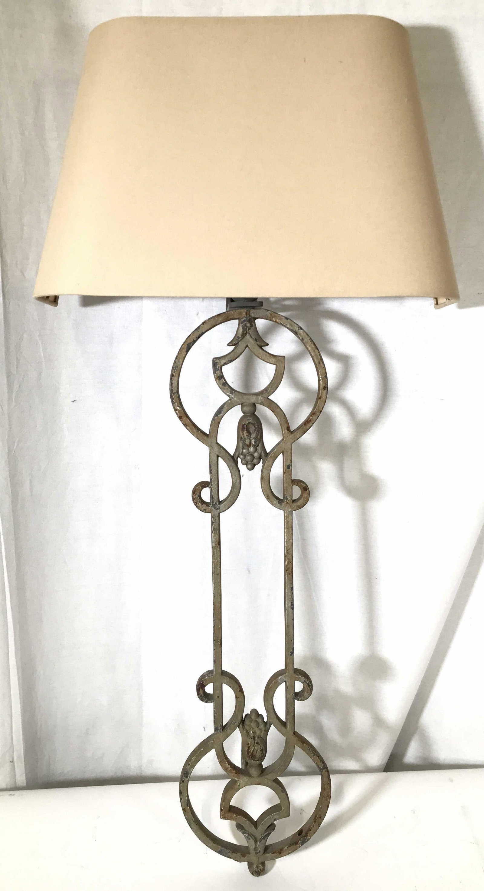 Pair Of Cast Iron Belgian Wall Lights W Shades: Wall lights are cast Iron. Each were originally purchased In Brugges Belgium from a European villa. Each include cream toned linen shades. Each measures approximately 31 inches tall 8 inches wide 18 i