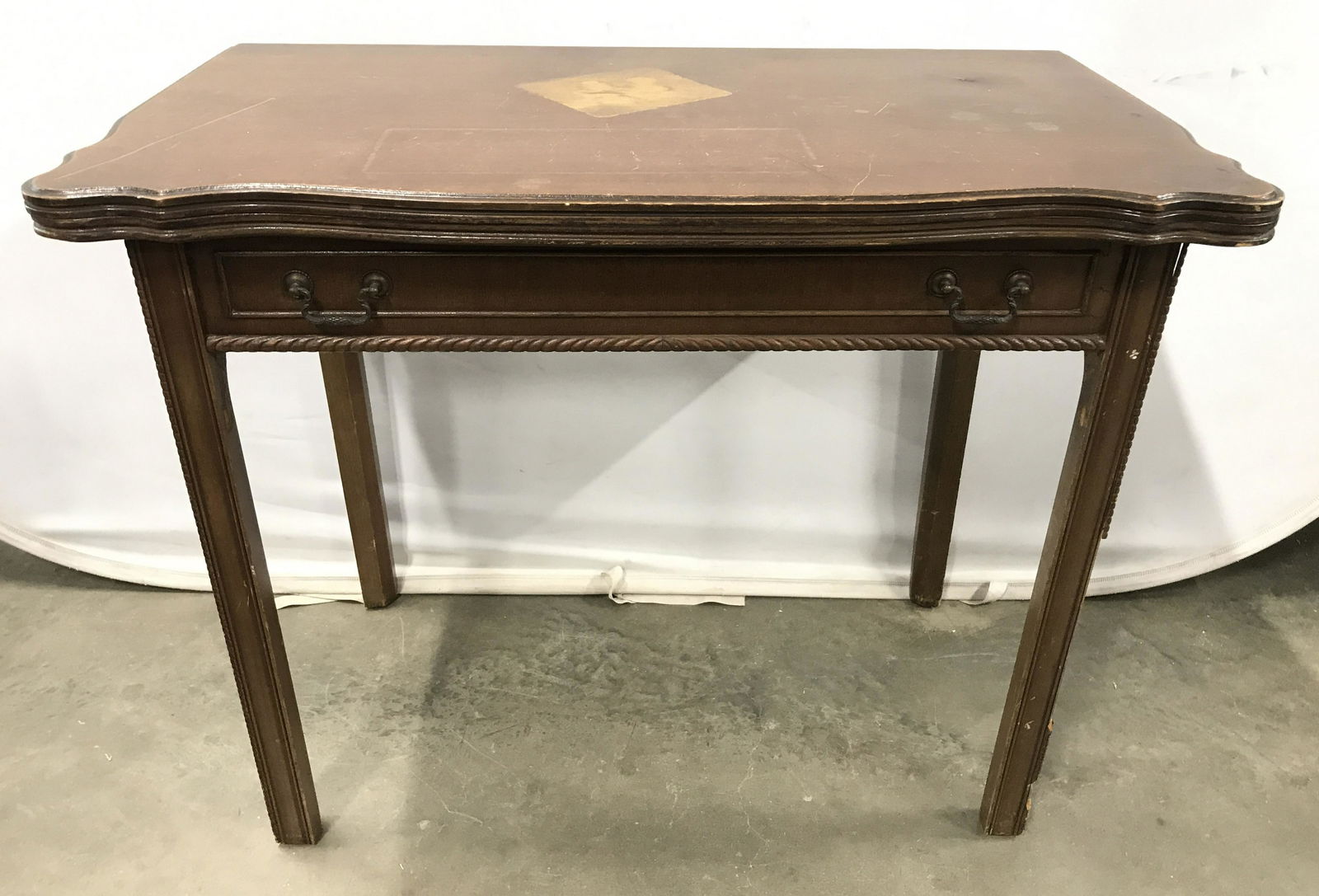 Vintage Carved Wood Flip Leaf Table: Vintage carved wood table, possibly antique. Carved wood trim on leg corners and front of table produces a rope like form. Rear table legs slide out and support the flip leaf table top. Hinges of flip