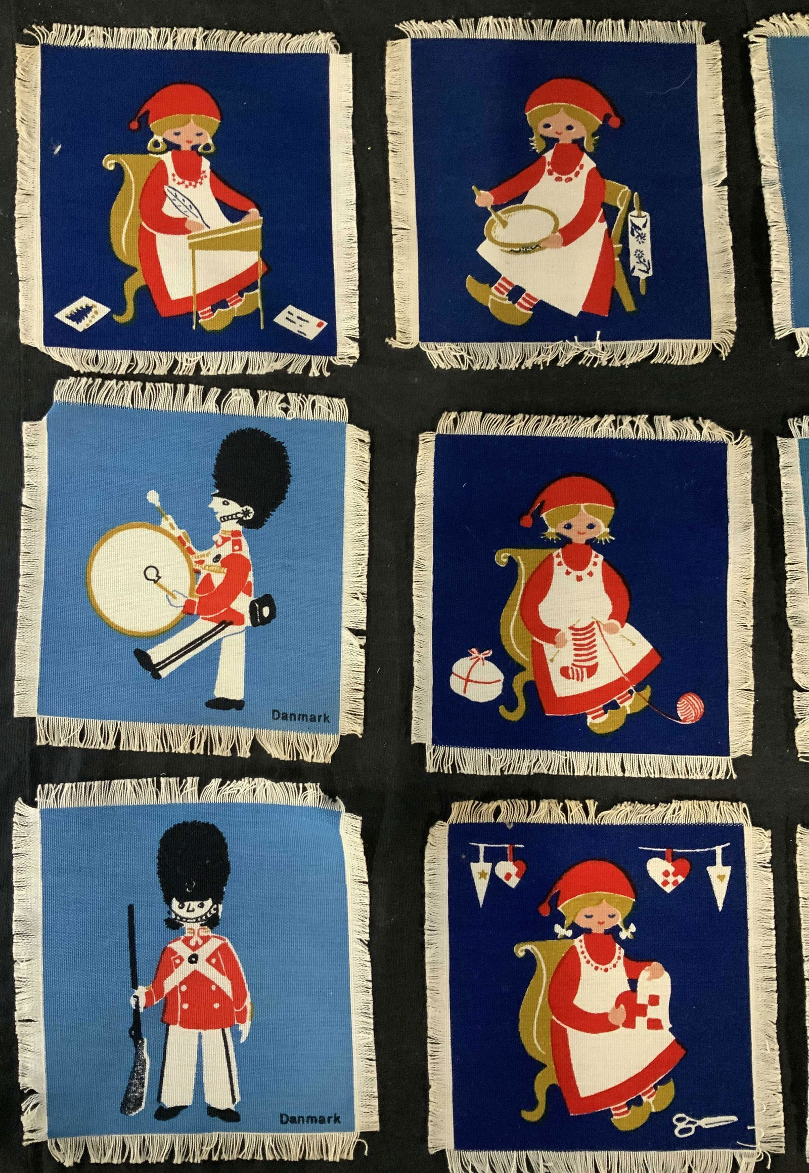 Lot 19 Danish Fabric Coasters: Lot 19 Danish fabric coasters, inscription to pieces reads ‘Danmark’, ‘Skovshoved’, ‘Fano’, ‘Amager’, coasters feature various figures and map of Denmark, all measure 5 7/8 x 5 5/8 inc