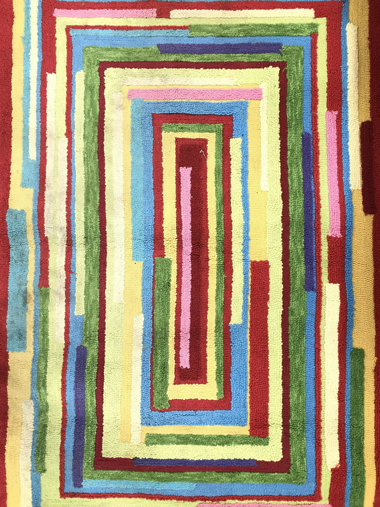 Geometrically Detailed Multi Toned Rug: Rug is contains intricate multi toned geometric detail. Piece measures approximately 64 inches long 42 inches wide. Rug is possibly wool, possibly polyester, possibly olefin. Rug, carpet, area rug, ar