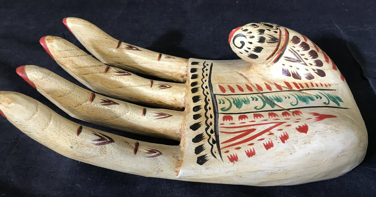 Lot 2 Indonesian Hand Painted Wooden Sculptures: Two Indonesian hand painted wooden sculptures, both pieces have label to underside that reads ‘Made in Indonesia’, sculpture one depicts a wooden hand with floral design, sculpture depicts an elon