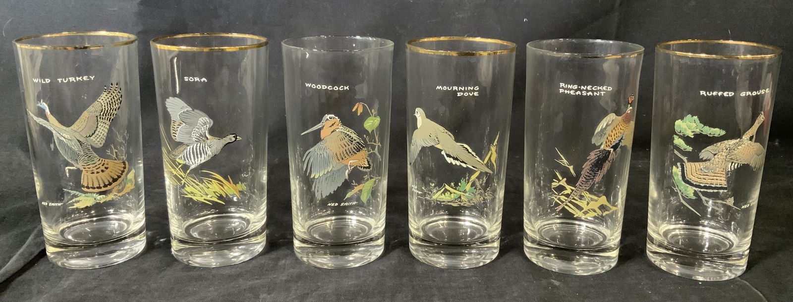 Set 6 NED SMITH Glasses w Woodland Bird Artwork: Set 6 NED SMITH Glasses w Birds, inscriptions read ‘Ned Smith’, ‘Wild turkey’, ‘sora’, ‘woodcock’, ‘mourning dove’, ‘ring necked pheasant’, ‘ruffed grouse’, all measure 5 5