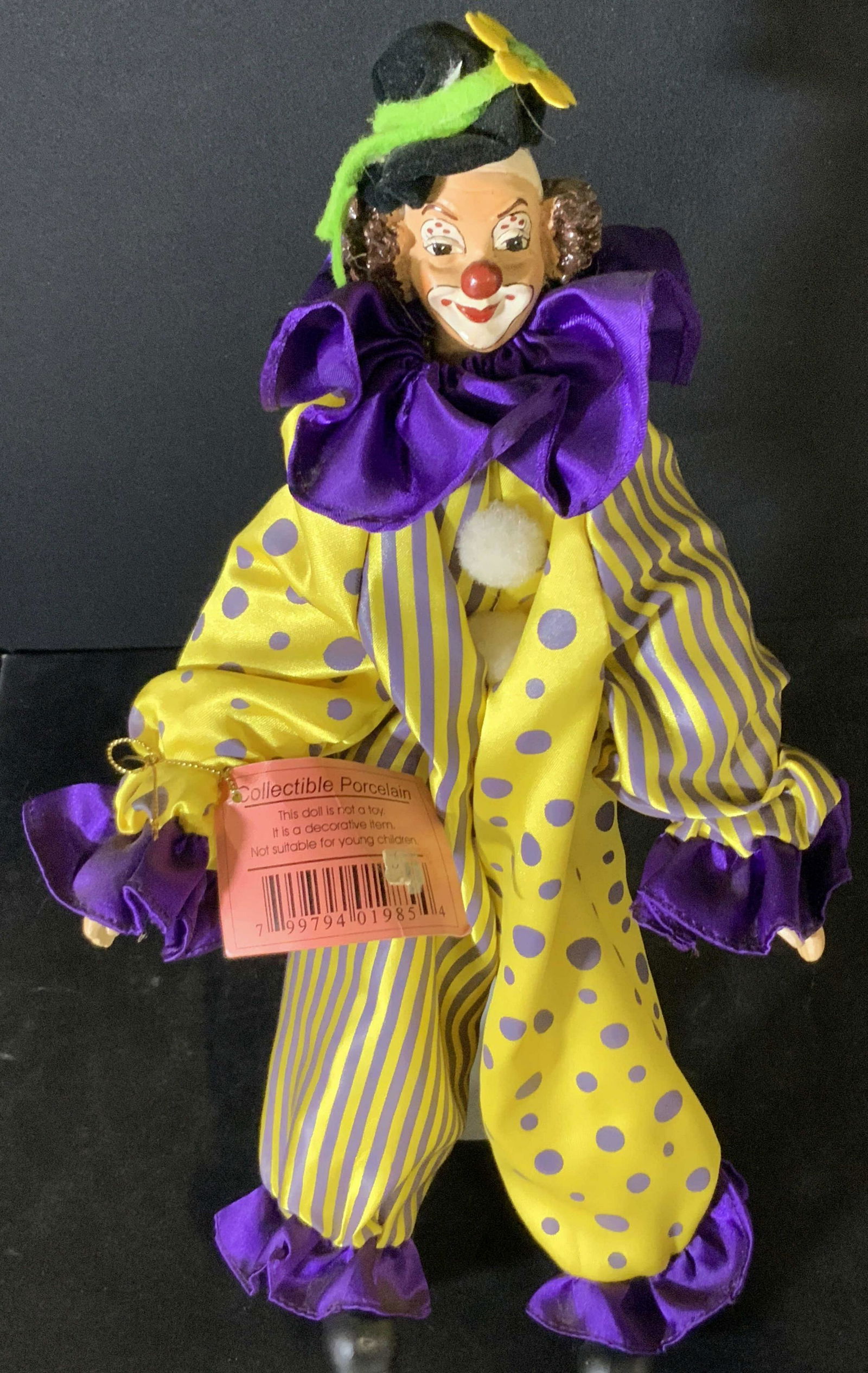 BUBBLES Collectible Porcelain Standing Clown Doll: A standing clown doll that comes with a stand that it is affixed to. The metal stand allows the clown, Bubbles, to stand alone. A pink tag attached to Bubbles’ arm reads: Bubbles, Show Stoppers Inc,