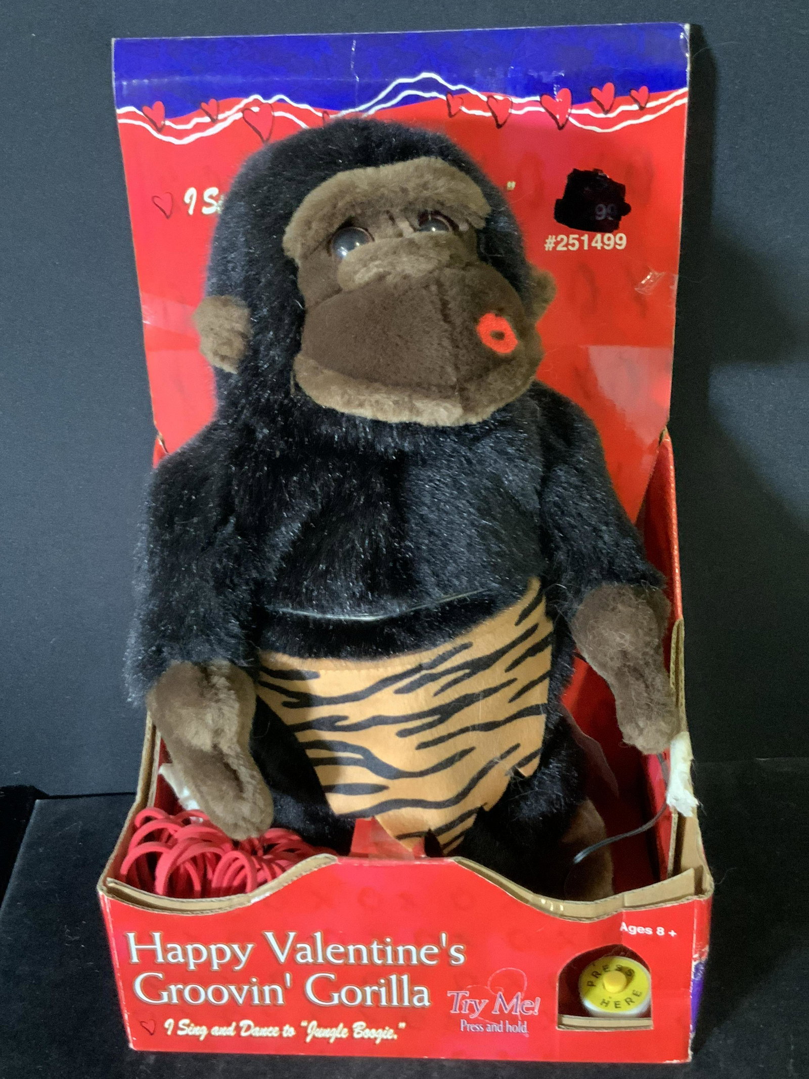 Vntg. Happy Valentine’s GROOVIN’ GORILLA, Org. Box: A plush gorilla toy, Happy Valentine’s Groovin’ Gorilla, in it’s original packaging. The gorilla is a soft, plush material. It is black & brown and wearing zebra print cloth. He has a stitched k