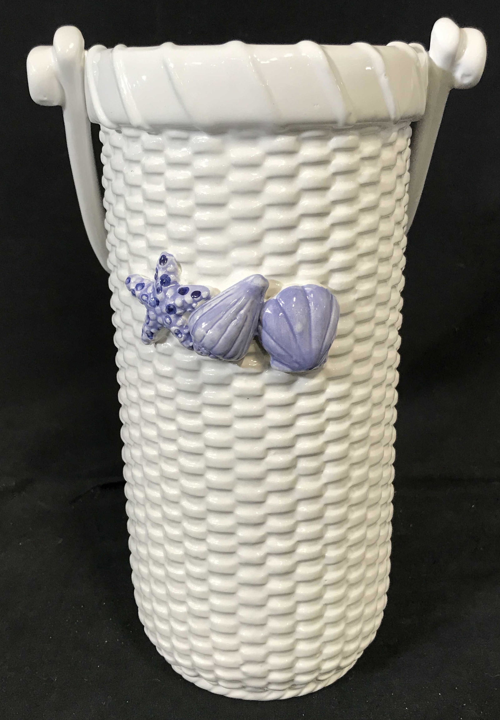 Ceramic Basket Vase with Shell Design: Ceramic basket with shell design vase, no apparent signatures or labels, subject a ceramic vase made to appear as a wicker basket, vase has two seashells and a starfish designed to the front of the ba