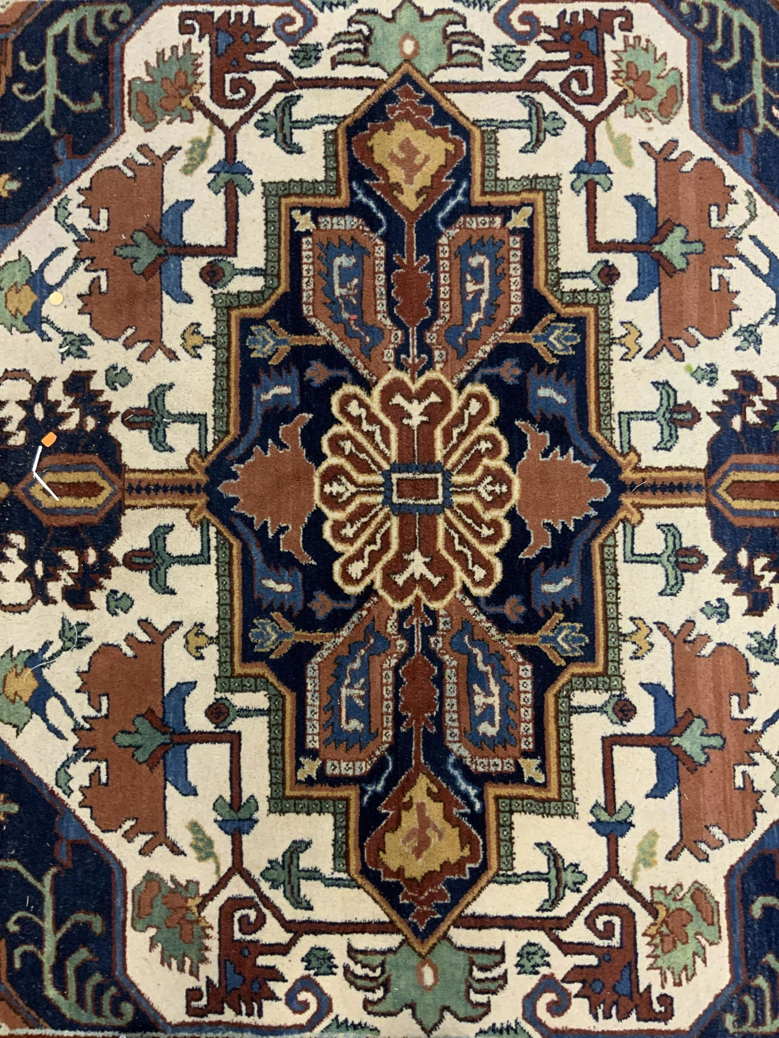 Antique Persian Area Rug: Antique Persian rug, possibly hand made. Decorated by floral-like pattern, multi toned. Fringes on either end are worn, some missing. Measures approx 122 inches long, and 97 inches W. Wear is consiste