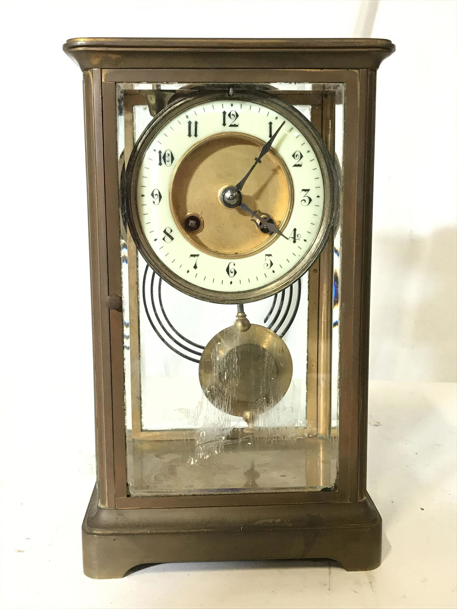 Vintage Brass & Glass Mantle Clock: Vintage, possibly antique mantle clock. Crafted from brass, and glass. Measures approx 10.14 inches H, and 6 inches W. Wear is consistent with age and use. Wind up key is absent. Clocks, home decor, m