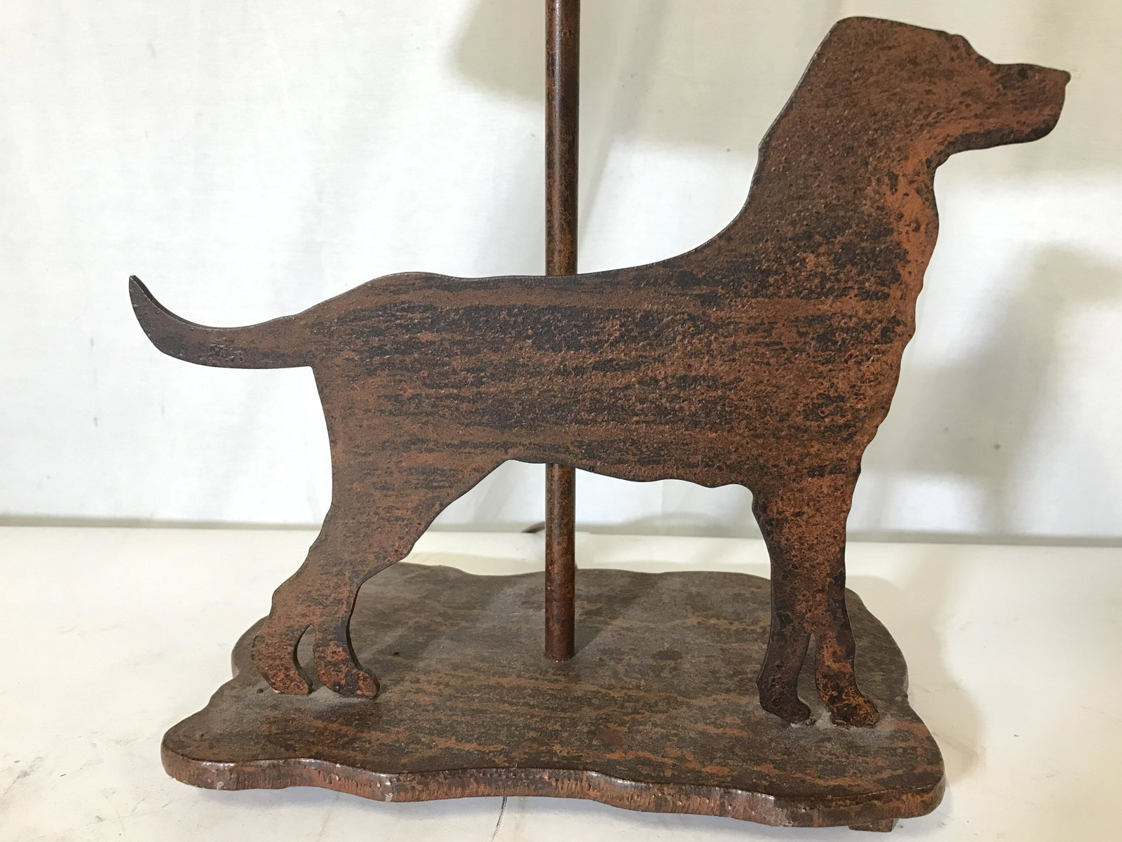 Vintage Cast Iron Dog Lamp: Vintage cast iron lamp. Cut iron resembles a dog, lamp finial has been shaped into a bone. Measures approx 22 inches H, 14.75 inches W. Wear is consistent with age and use. Lighting, home decor, metal