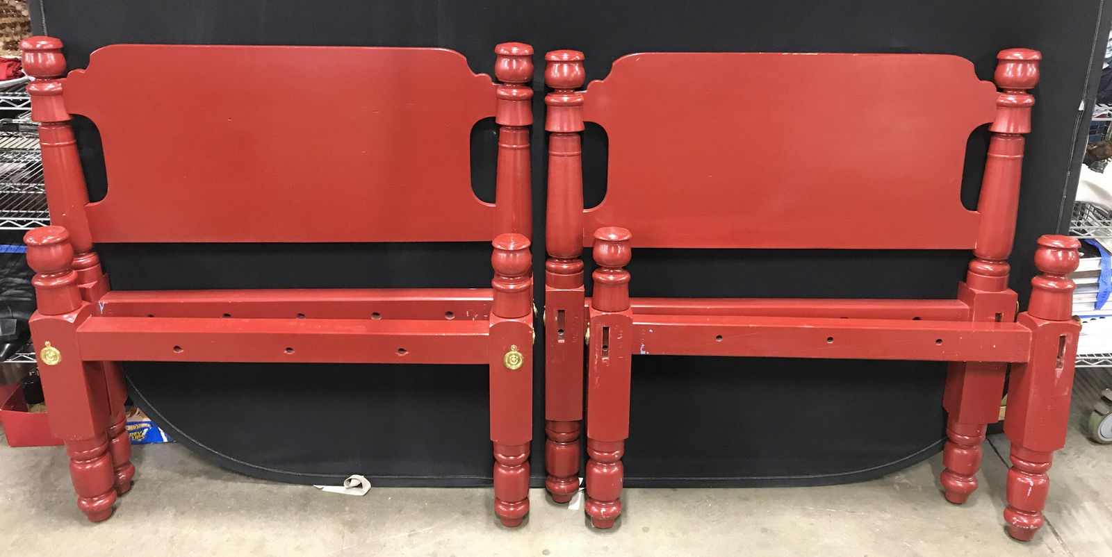 Pair Antique Red Toned Headboards & Footboards: Pair of wooden antique headboards and foot boards. Boards have been painted red, sockets are covered by brass medallions. Larger pieces measure approx 42 inches H, and 42 inches W. Wear is consistent