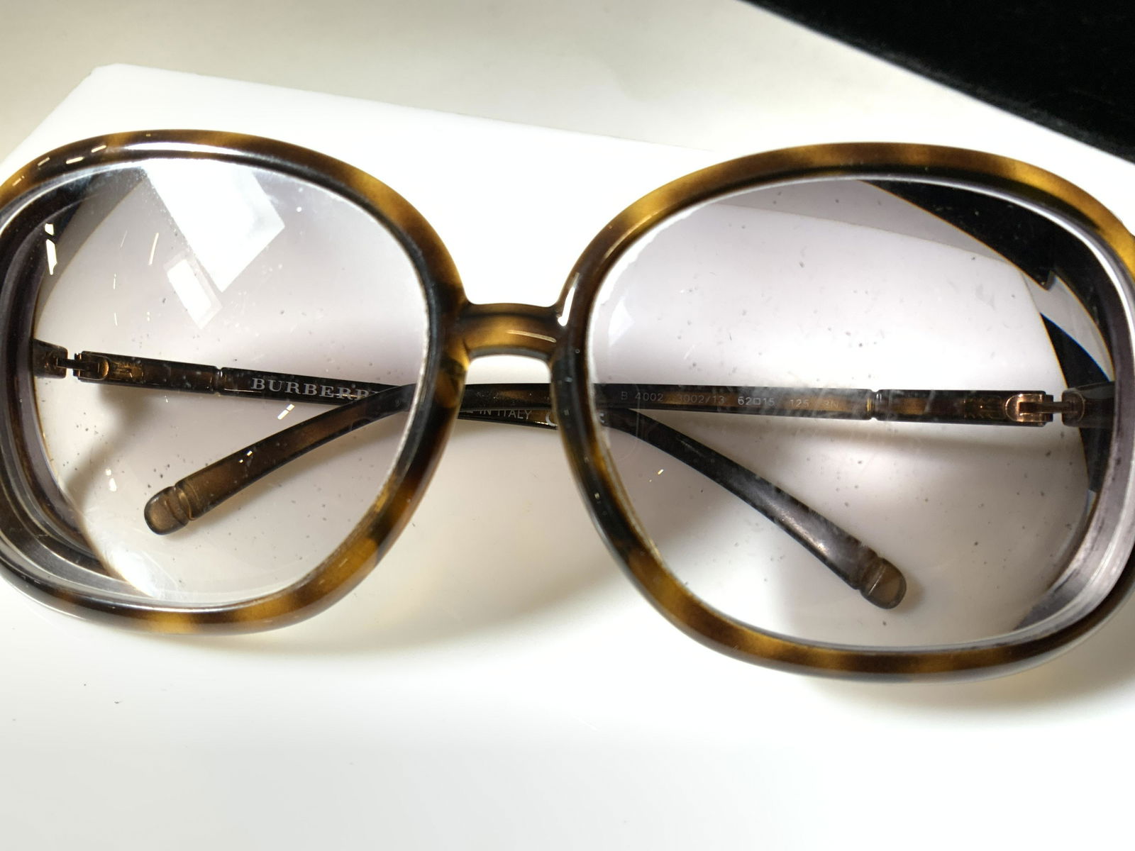 BURBERRY B 4002 3002/13 Sunglasses, Italy: These Luxury Burberry Sunglasses are made in Italy. The Frame is structurally intact and well-balanced with minimal scratch marks. Thin composite Tortoise shell color frames with large square shape ey