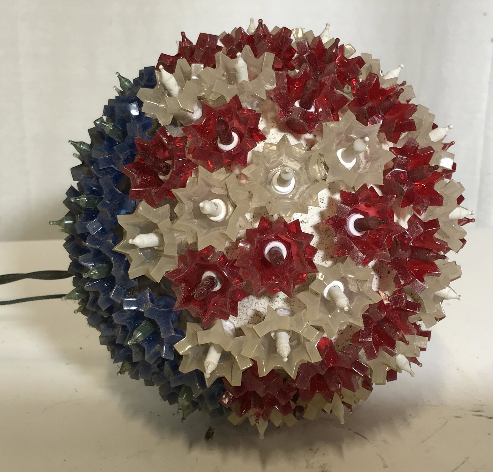 American Flag Hanging Light Orb: American flag hangin light orb, light fixture does not work, piece comprises of a white orb with lights coming from it each with a colored fixture in either red white or blue, piece measures 7.5 inche