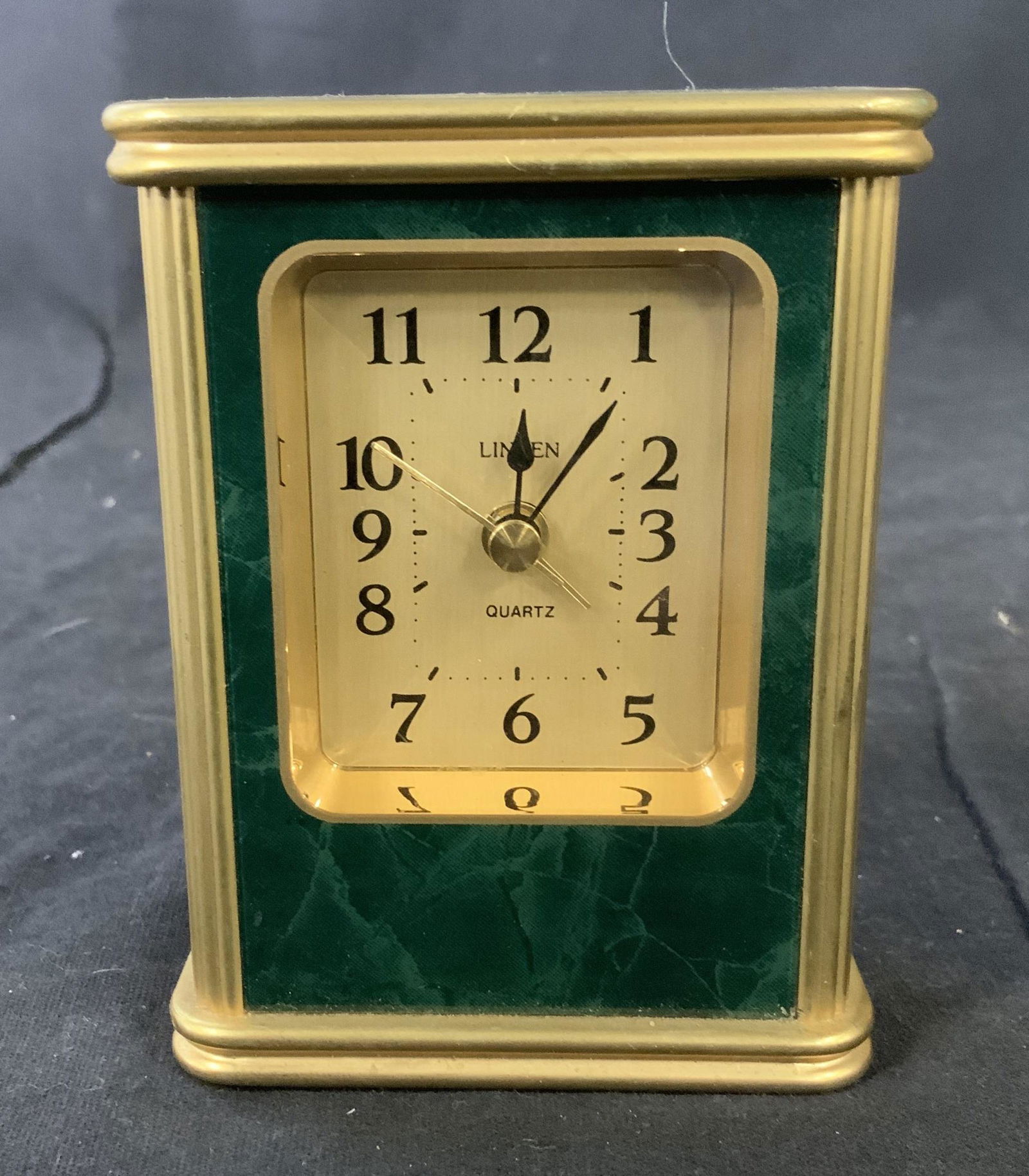 Linden Malachite Style and Gold Toned Table Clock: Linden Table Clock, inscription to clock reads ‘Linden Quartz’, and ‘Taiwan’, comprised of composite materials, measures 3 3/4 inches tall x 2 7/8 inches wide, some minor scratches but overall