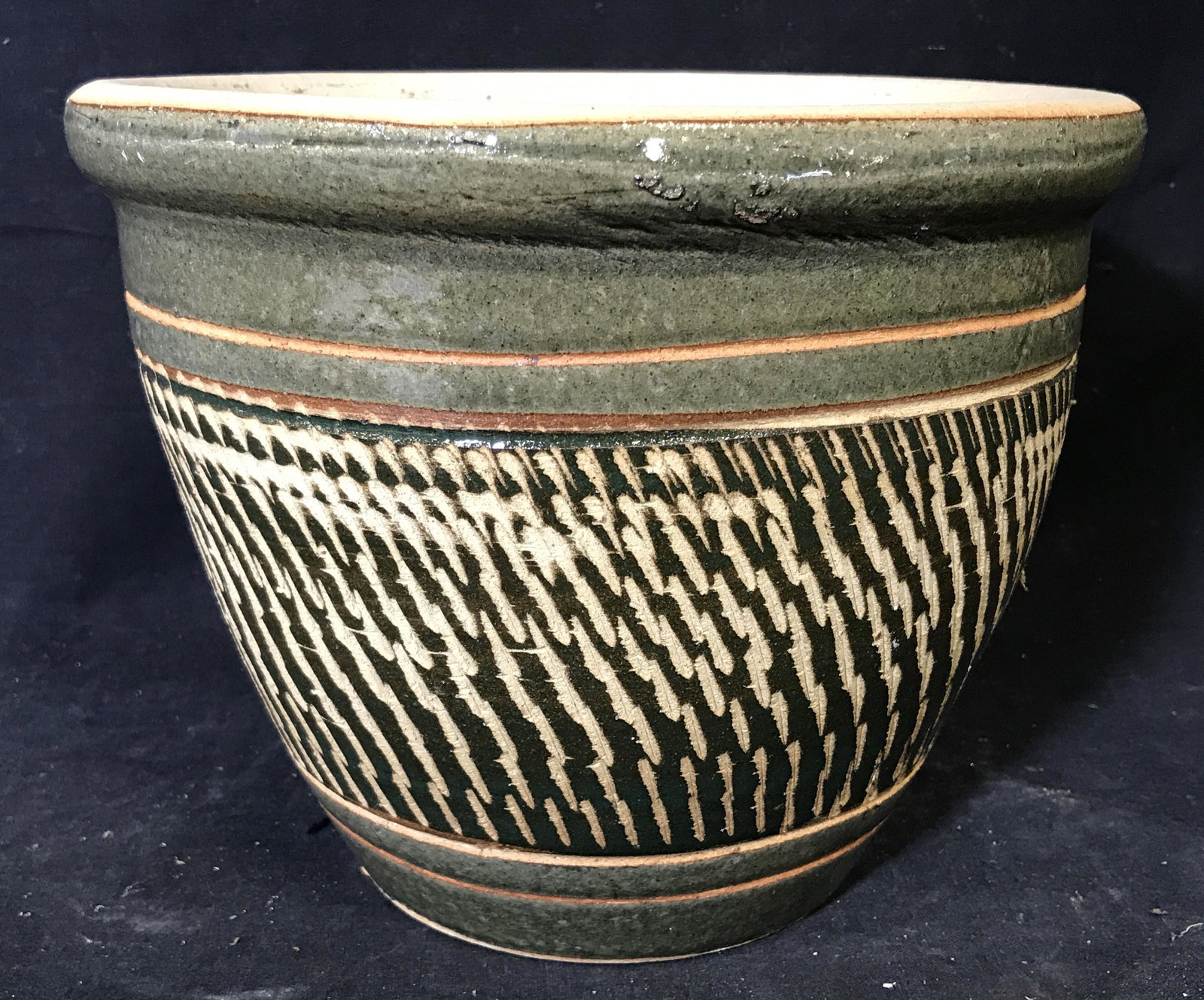 Green & White Glazed Ceramic Pot: Green and white glazed ceramic pot, sticker residue to one side of pot, outer surface of pot is green with carved designs into it thus using the natural white color of the clay, measures 7.5 inches ta