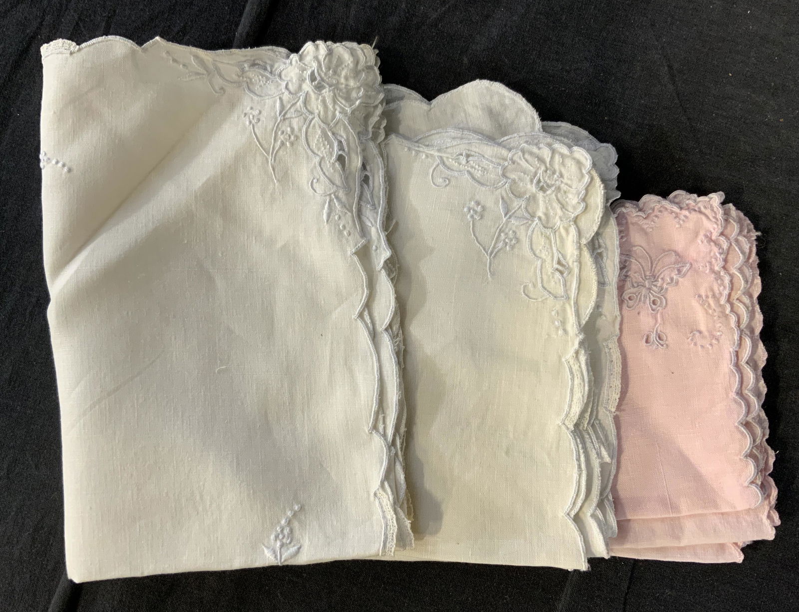 Lot 9 Vintage Embroidered Napkins: Lot 9 Vintage Embroidered Napkins, possibly French antique, no apparent inscriptions or labels, embroidery flower and butterfly designs, pink napkins measure 11 x 10 5/8 inches, larger square napkins