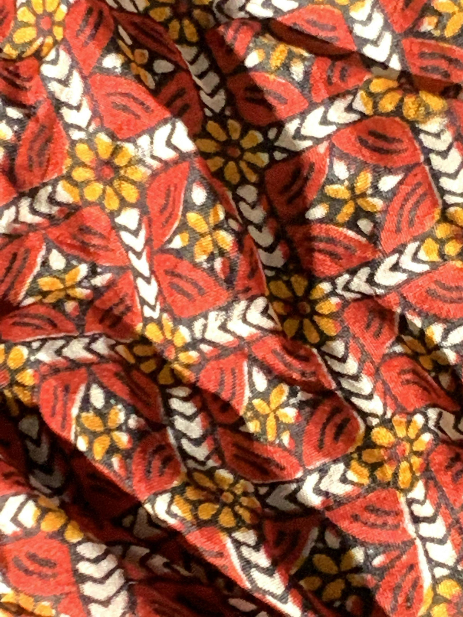 Lot 2 Vintage Scarf and Handkerchief: Two vintage accessories, a scarf & handkerchief. Both pieces possess red patterns. The hanky is primarily white with red floral designs. Hearts are throughout this piece as well. The scarf is a soft h