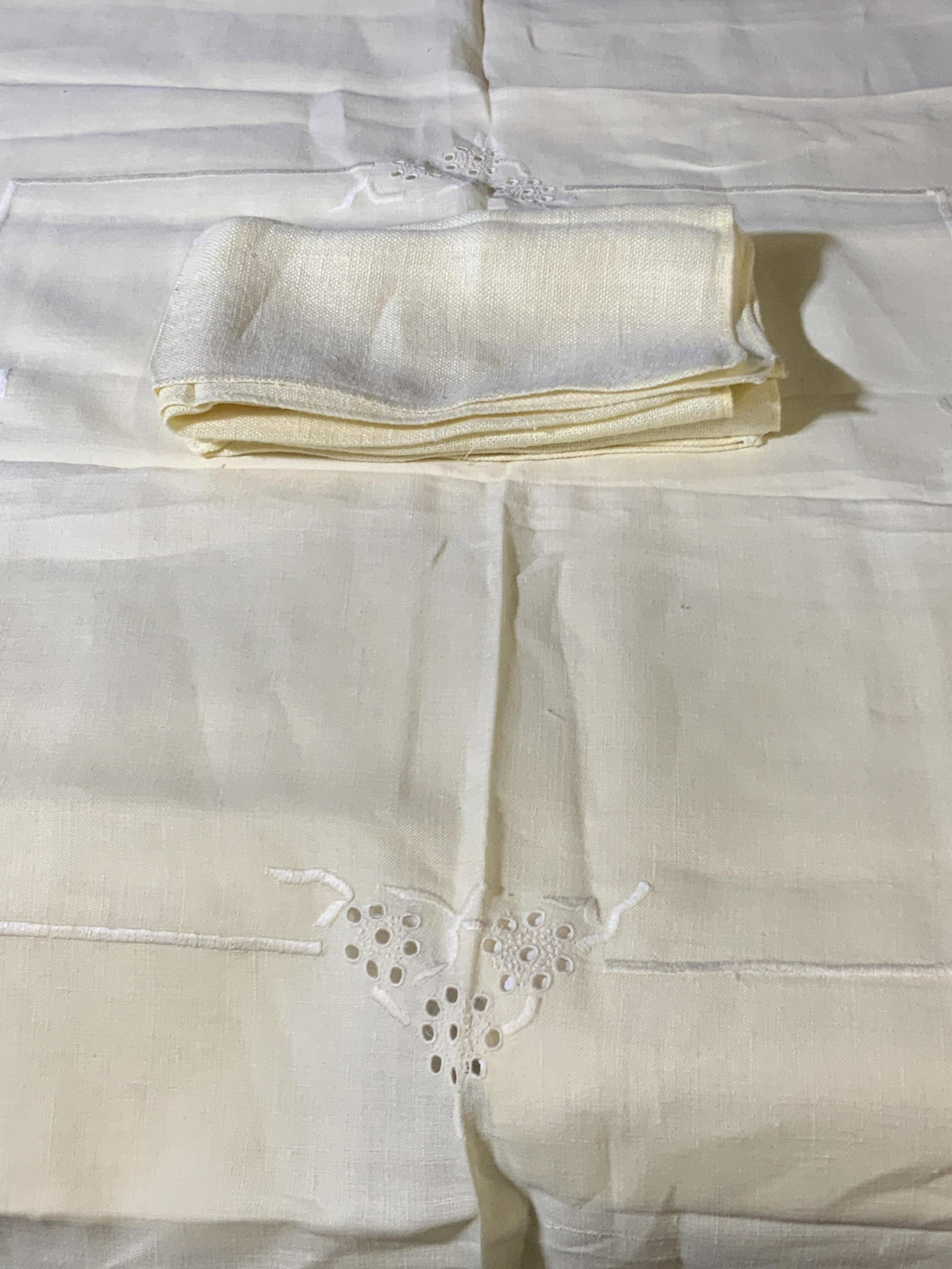 Set 3 Vintage Embroidered Yellow Table Linens: One vintage square tablecloth & two vintage napkins. Yellow in color with pierced linen & embroidered accents. Tablecloth measures approx. 41 x 41 in. Mild tears in tablecloth. Vintage Napkins, collec