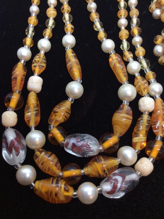 Glass and pearlescent beaded Jewelry Set: Necklace with Orange and white glass beads with swirl designs, possibly handcrafted, pearlescent style beads, three stranded graduated design, silver toned hardware, matching beaded Earclips, pieces m