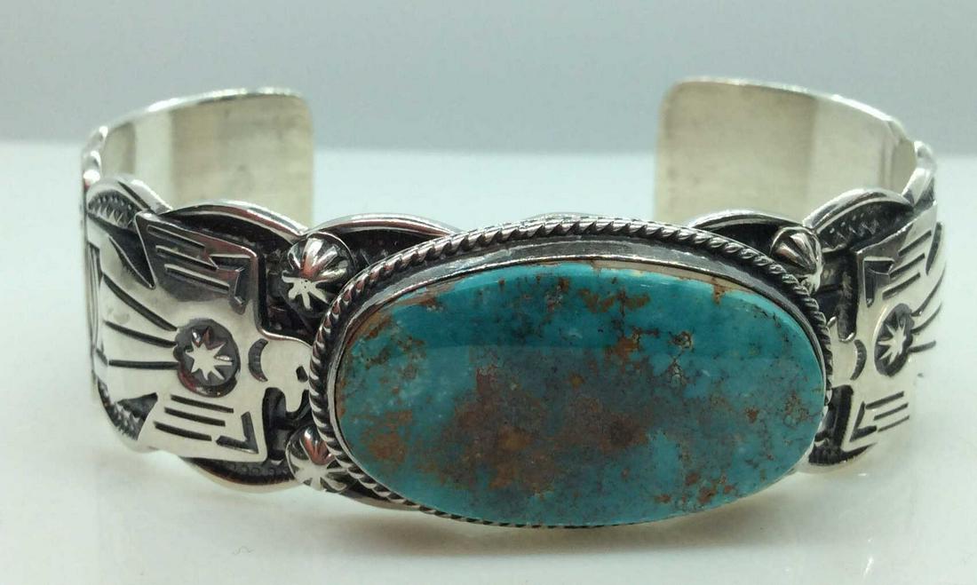 Gary Reeves Sterling Cuff Bracelet, Jewelry: With stone cabochon, possibly turquoise, sterling silver cuff bracelet, stamped on interior Gary Reeves Sterling, dimensional designs on band, stylized Eagle Figure, Stars and stripes, measures app 2 