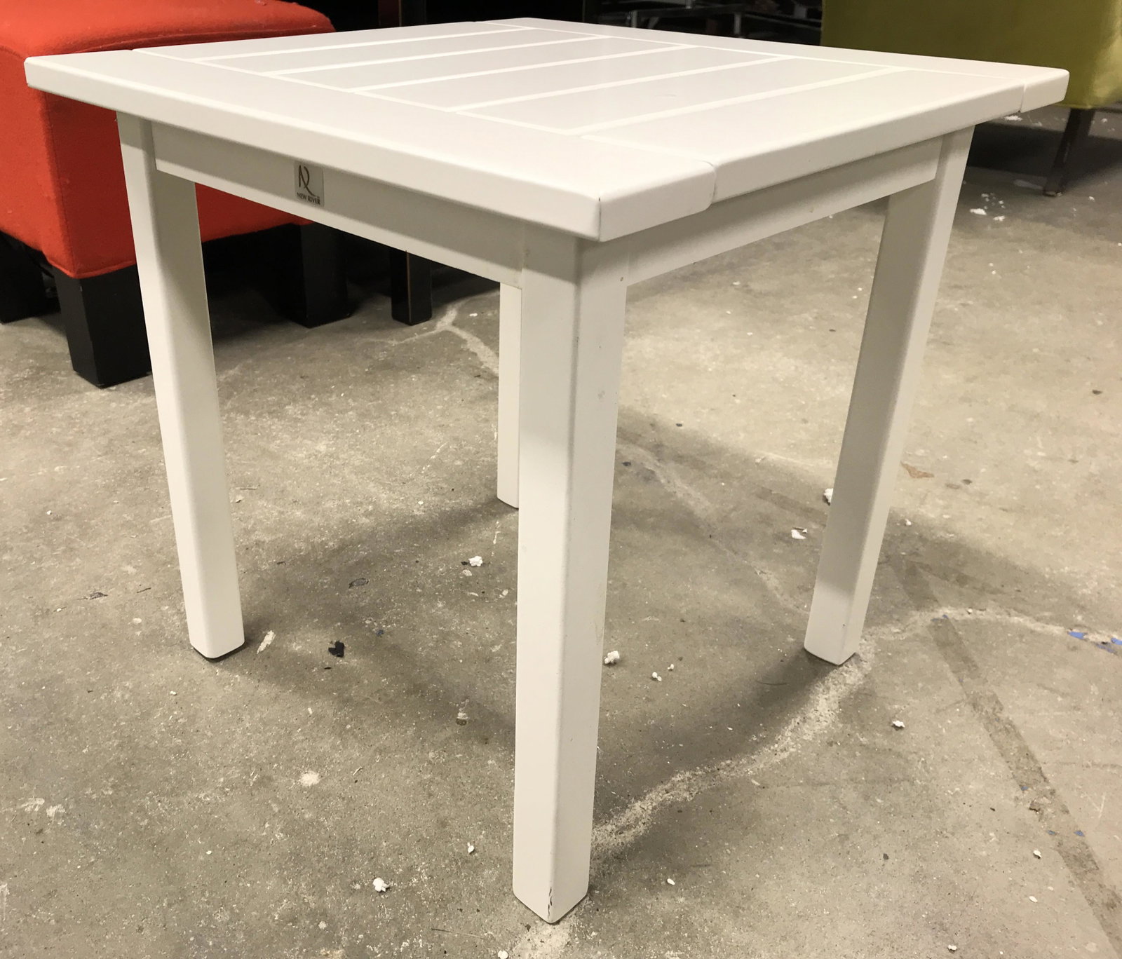 NEW RIVER Wooden Side Table End Table: Piece has tag which reads NEW RIVER table is white toned. Piece appears to be wooden, possibly veneer. Table has 4 legs. Piece measures approximately 18 inches tall wide and deep. Side table, end tabl