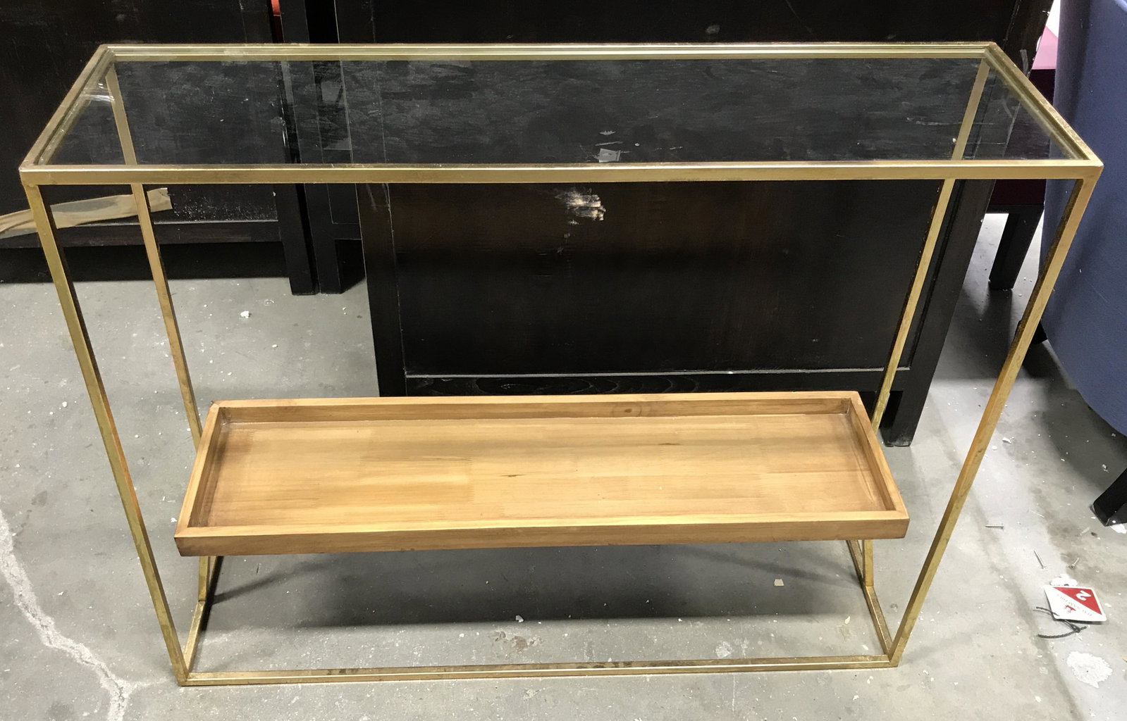 Gold Metal Glass Top Console Table: Gold metal glass top console table, no apparent tags or labels, body of table is made of thin gold toned metal with a glass top shelf and a lower wooden shelf, measures 31.5 inches tall, table top mea
