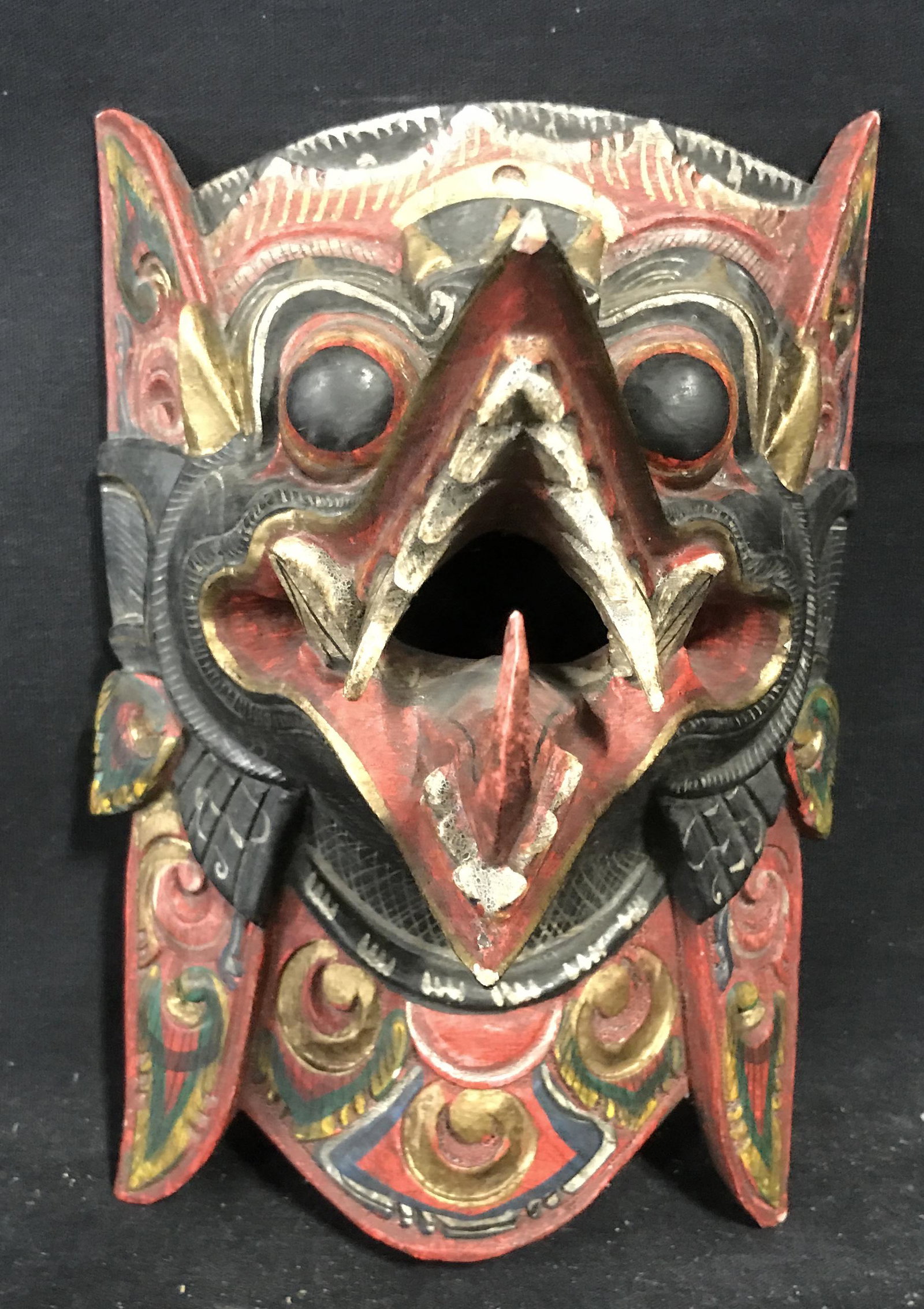 Balinese Wooden Figural of Rangda: Balinese wooden Figural of Rangda, no apparent marks or stamps, subject the Balinese goddess and demon queen Rangda with mouth opened wide and teeth bared, painted with red black white and gold pigmen